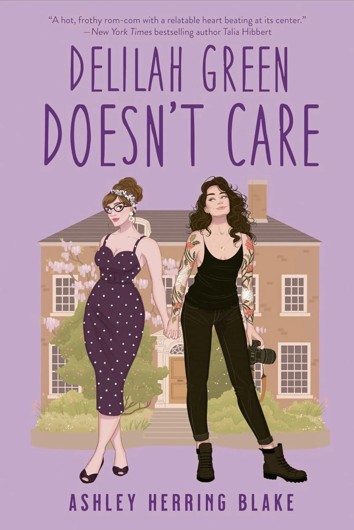 Cover of the book 'Delilah Green Doesn't Care' by Ashley Herring Blake, featuring illustrated two women holding hands in front of a house with a purple background.