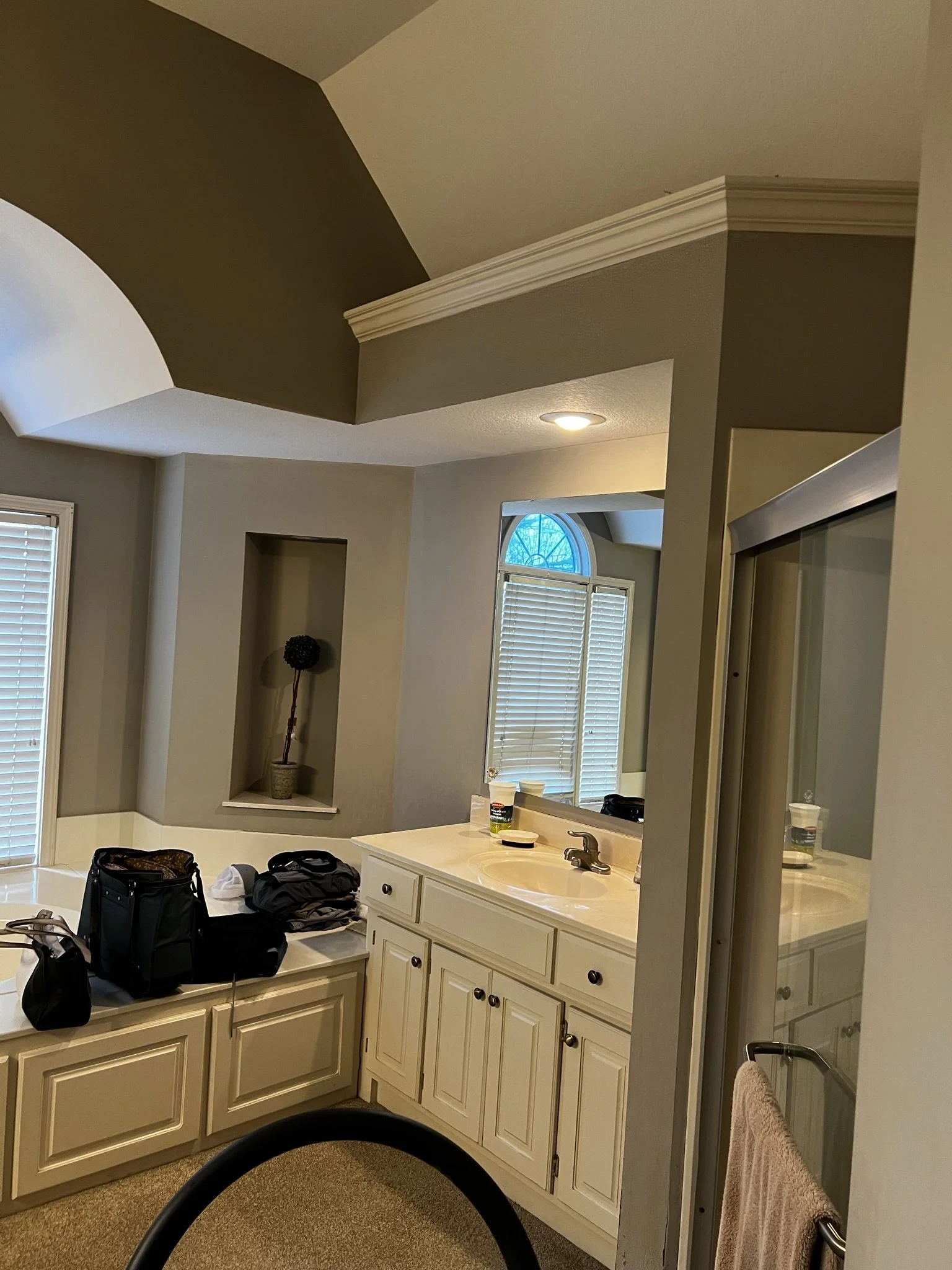 Before photo: primary bathroom with awkward vaulted ceiling and dated vanity, Overland Park KS