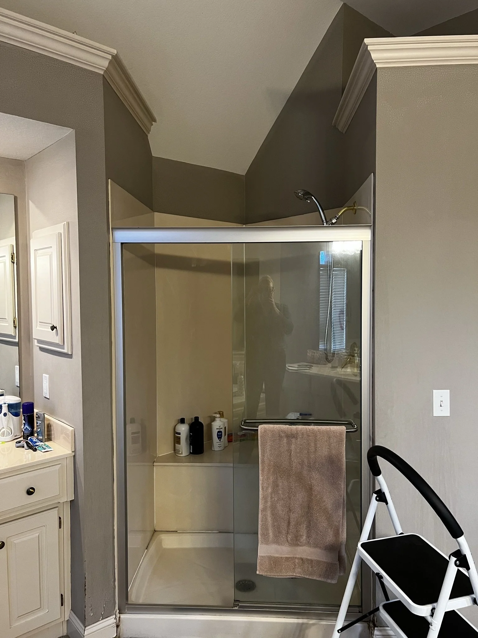 Before photo: basic glass shower stall in outdated primary bathroom, Overland Park KS