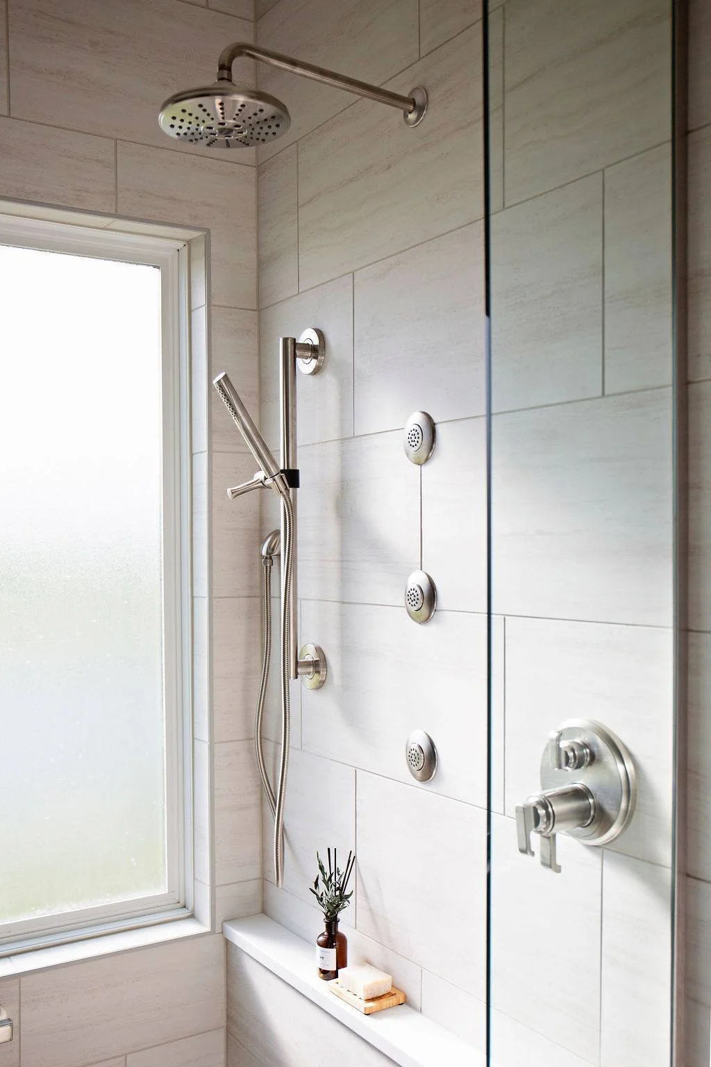 Rain shower head with sliding hand shower and multiple body jets in Pleasant Hill MO primary bathroom renovation