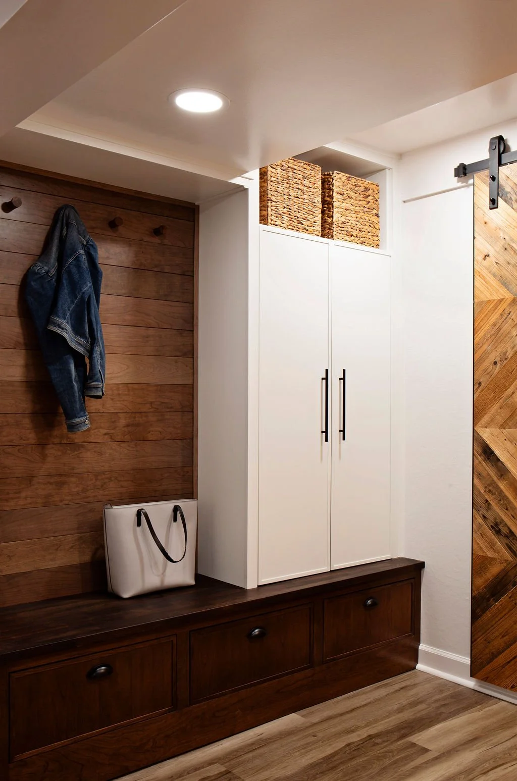 Mudroom and entryway renovation with custom storage, sliding barn door, and built-in cabinetry