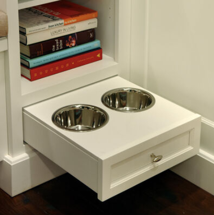 Built-in pet feeding station with pull-out bowls and integrated storage for food, treats, and pet supplies.