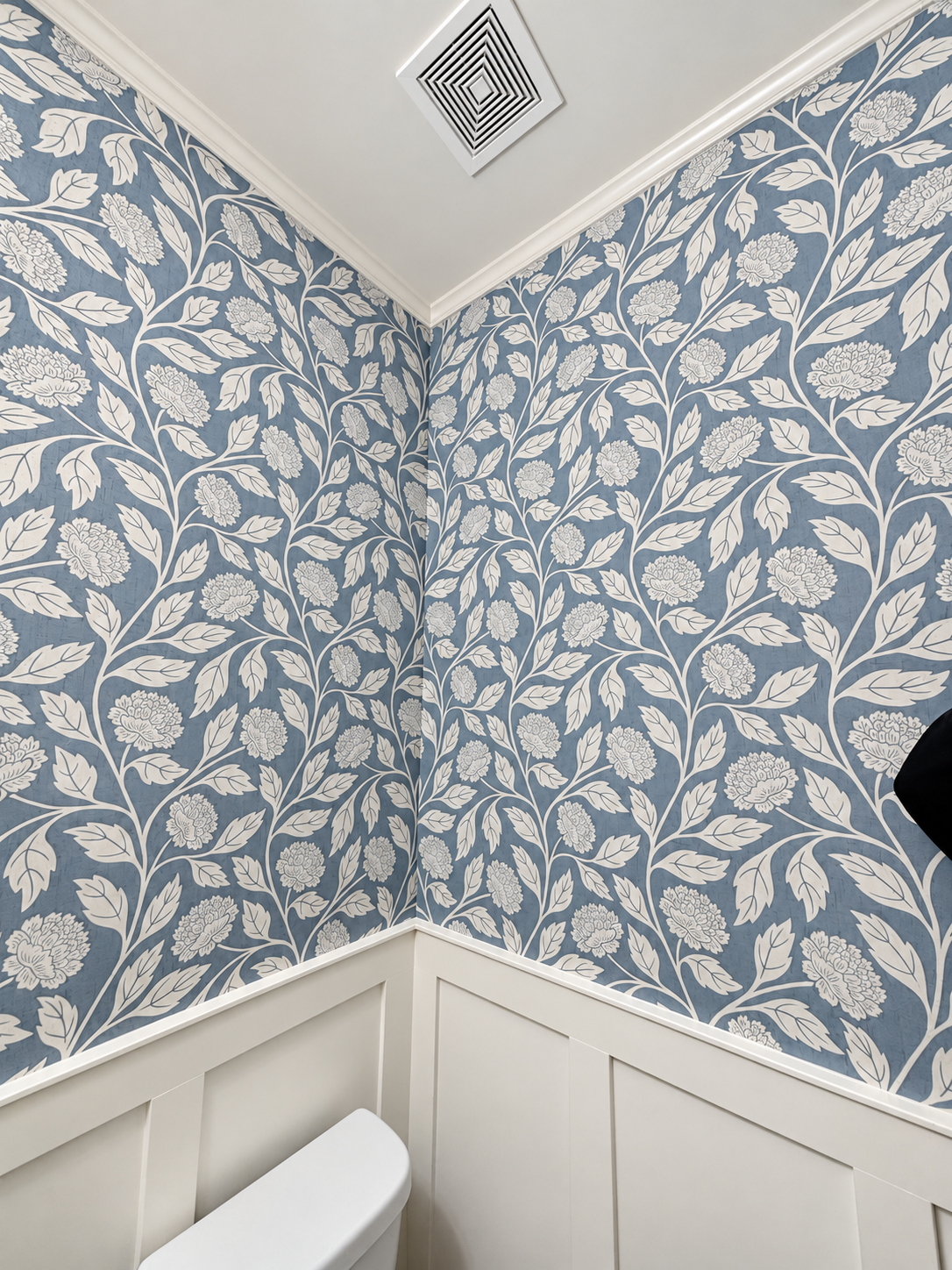 Bright powder room with elegant wallpaper.png