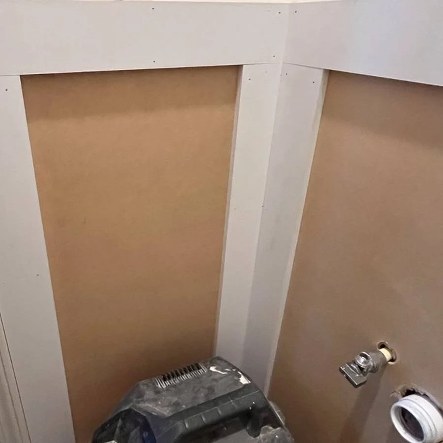 During: wallpaper and wainscoting installation is underway.