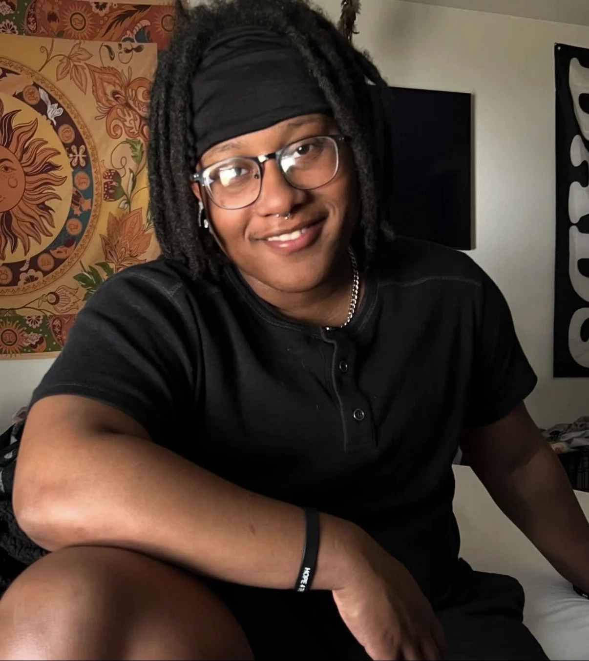 Xufflex, founder of PsychicHotline, smiling at camera while sitting at home.