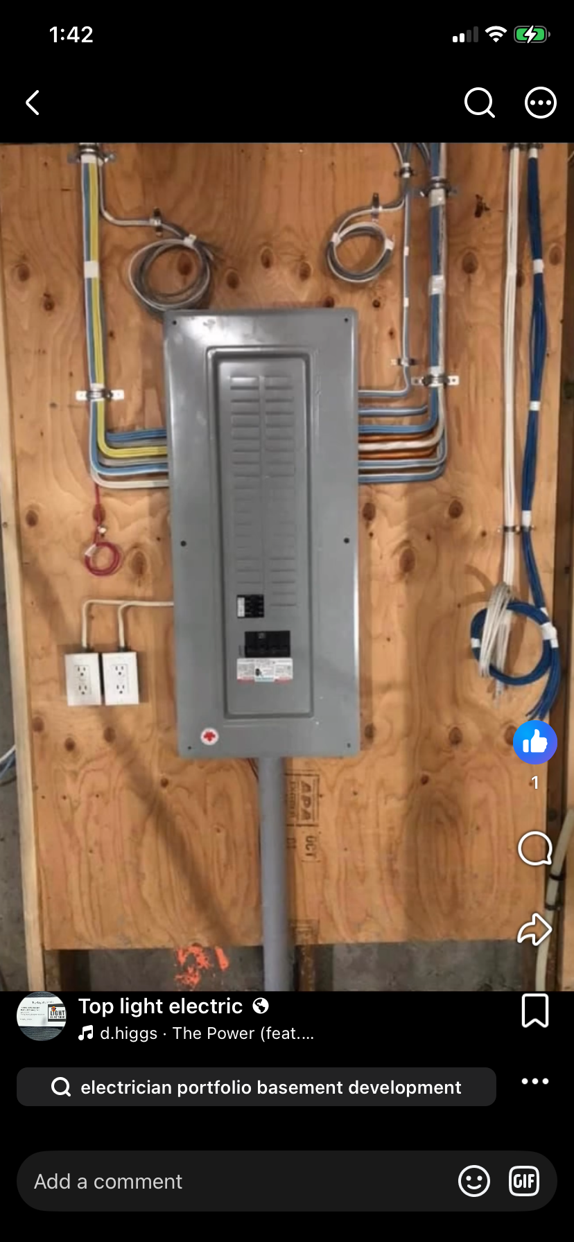 Electrical panel installed on a wooden wall with various colored wires and outlets.