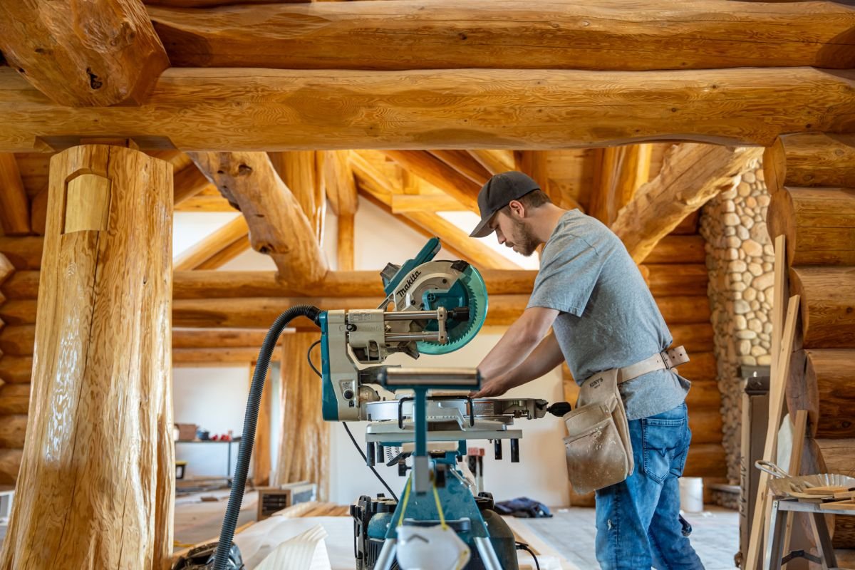 Construction worker sawing wood.JPG