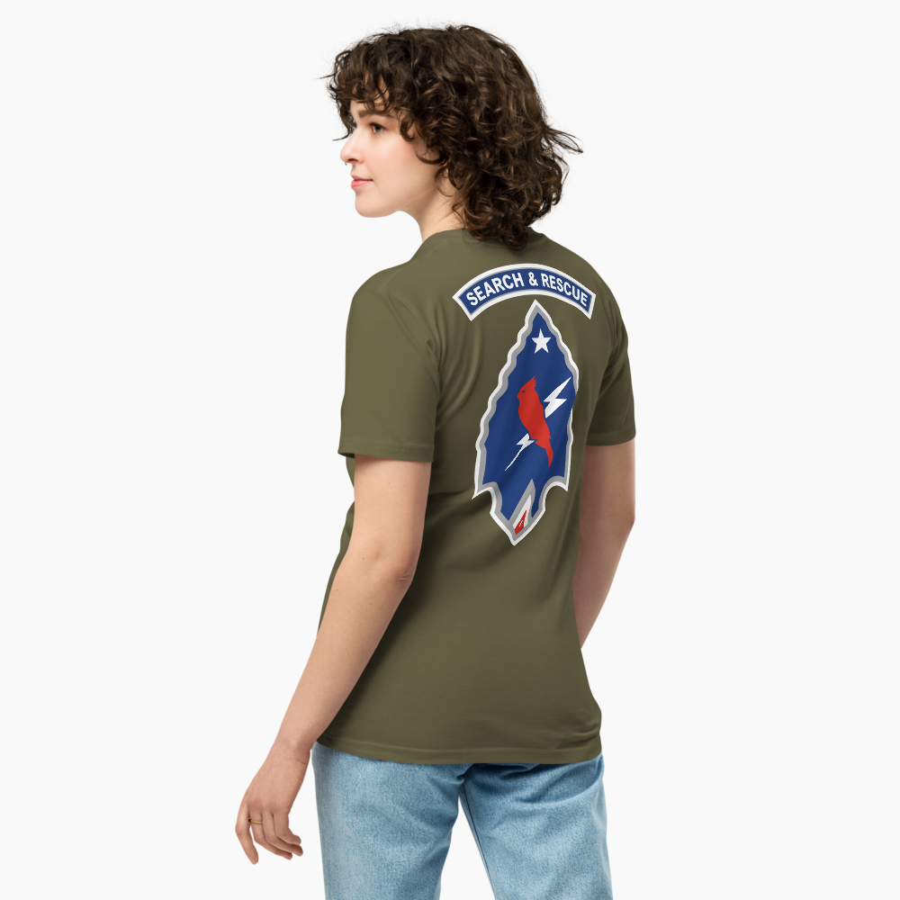A woman in a green T-shirt with a rescue patch on back, standing sideways against a plain white background.
