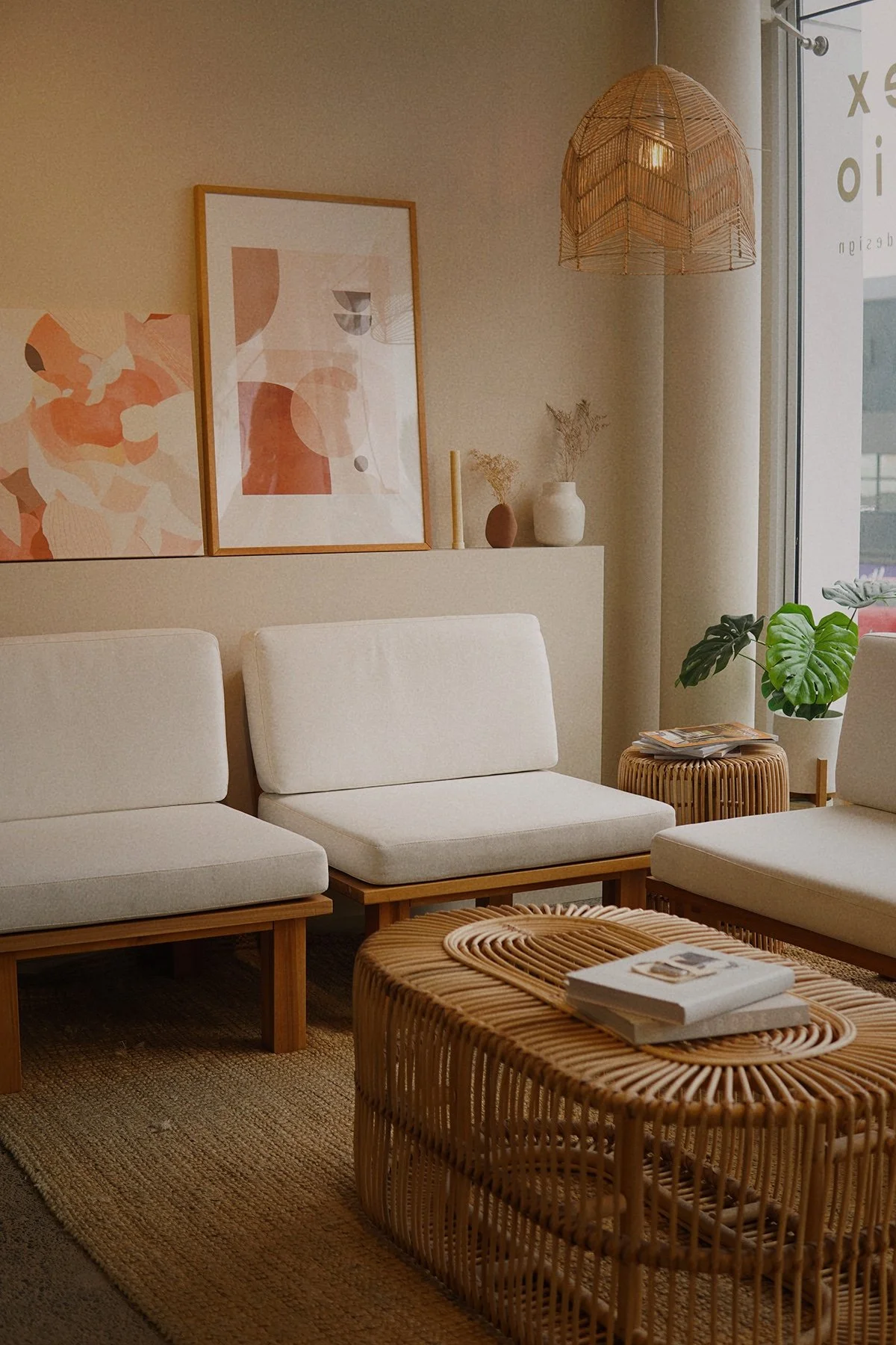 A modern, well decorated client waiting area with custom designer couch seating, a trendy coffee table with magazines. Natural light filters in through large windows. A welcoming space for their clients.