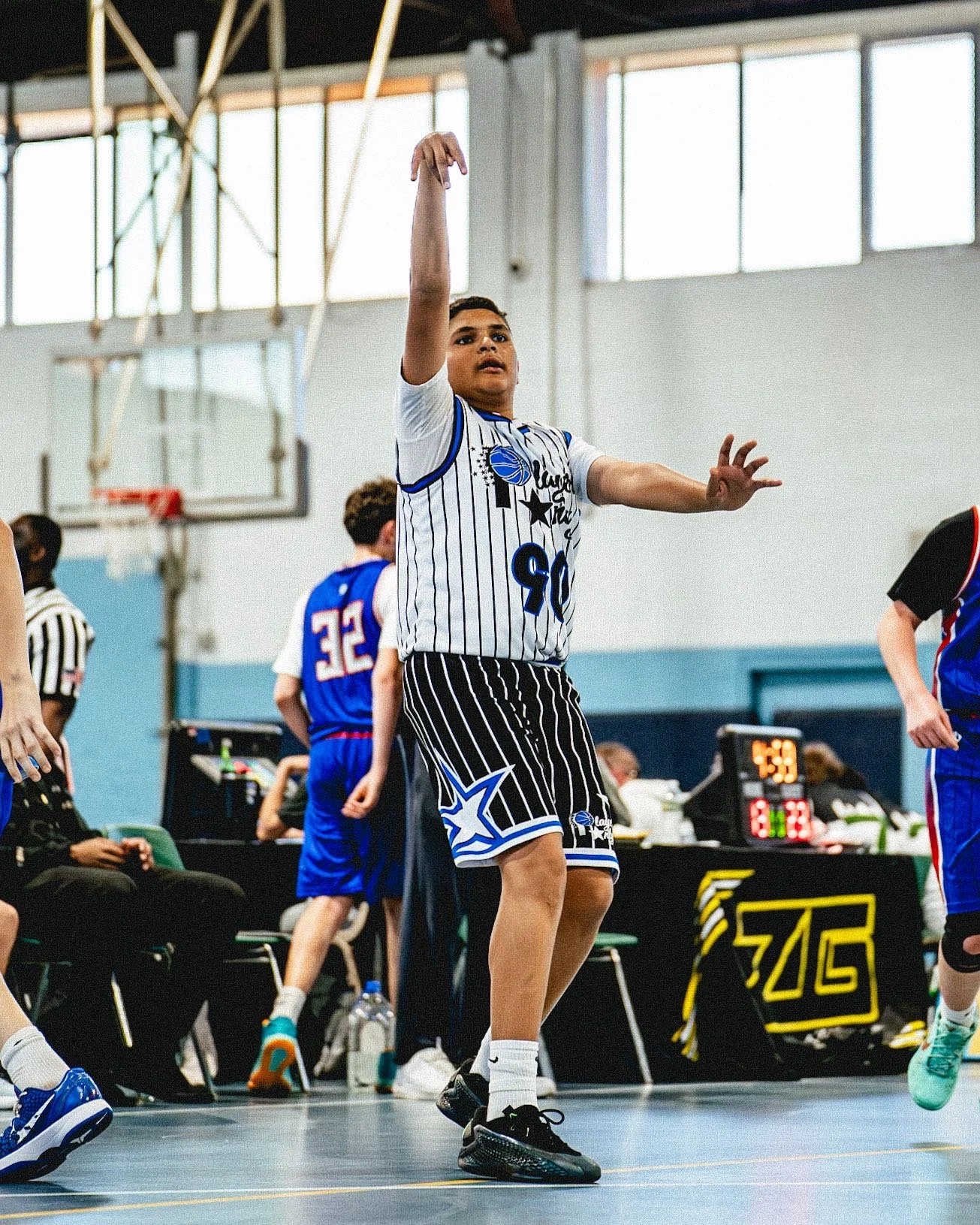 Players Only AAU basketball player finishing at the rim.