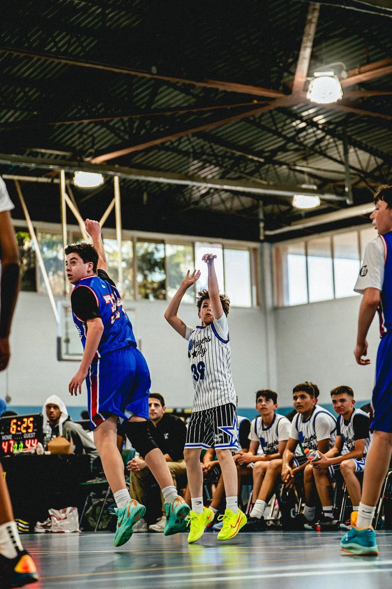 Players Only AAU basketball game action on the court.