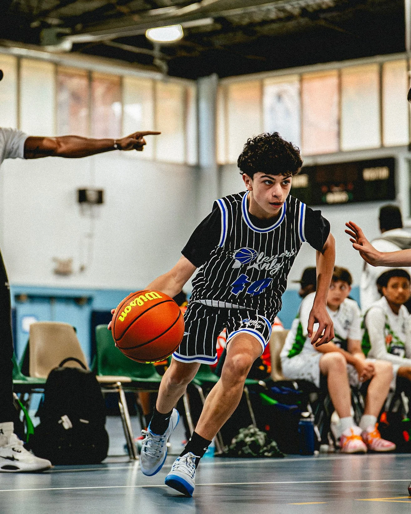 Players Only AAU basketball player driving to the basket.