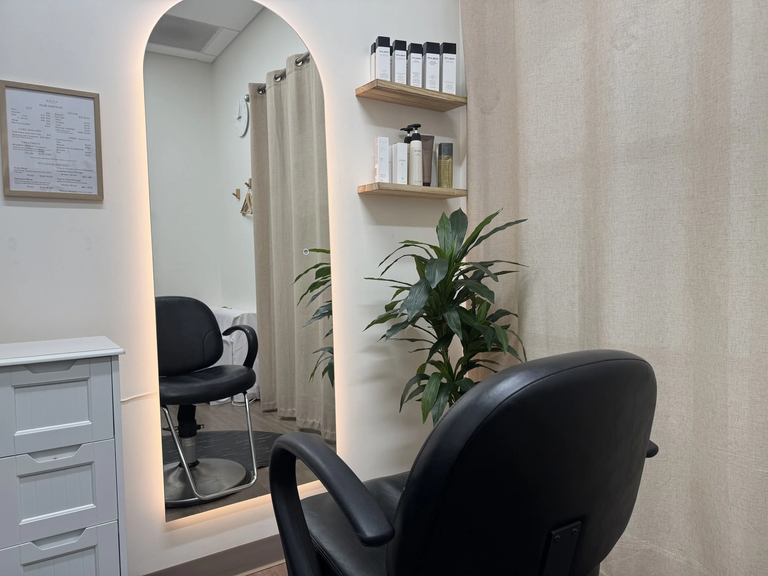 hair styling area with arched mirror at unico hair & wellness