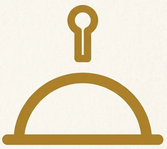A simple graphic of a covered dish with a cloche and a key above it, all in gold color.