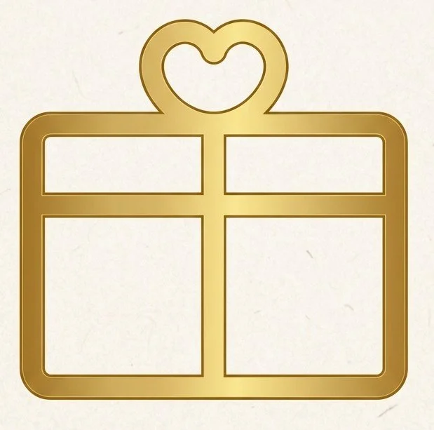 Golden heart-shaped present topper above a gift box with a heart-shaped bow.
