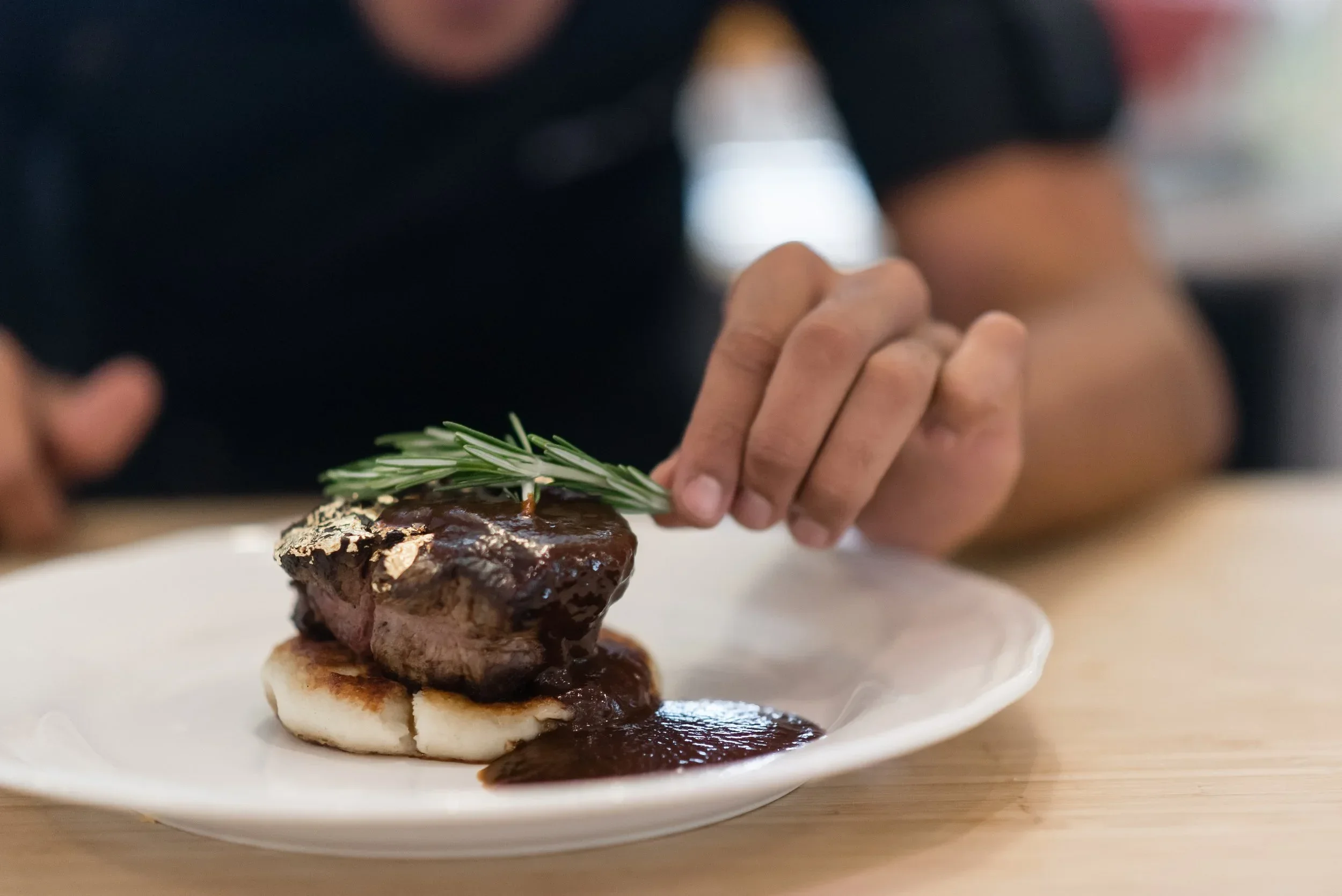 Gourmet steak course plated for luxury private dining experience