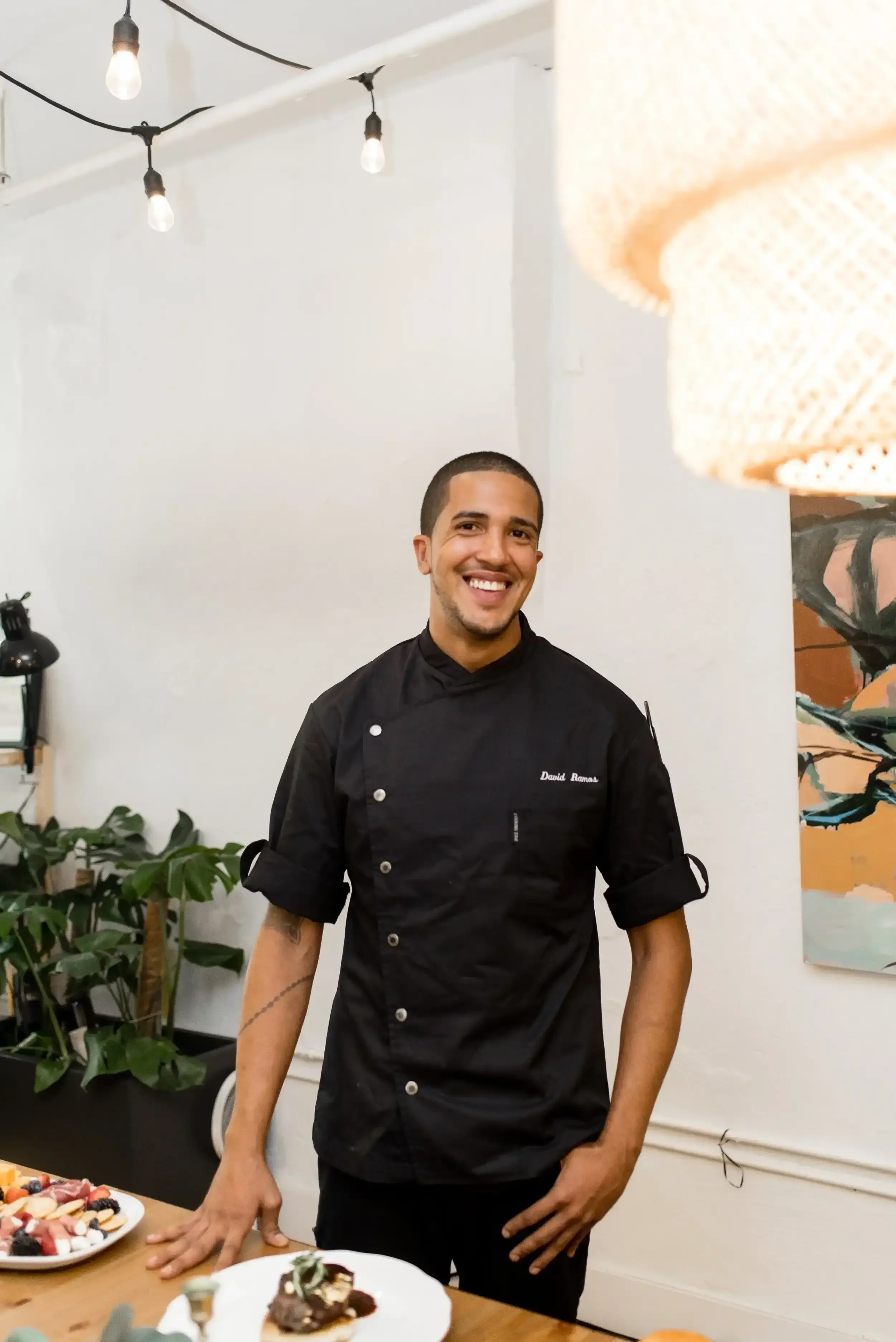 Chef David Ramos smiling in black chef jacket for private dining and consulting