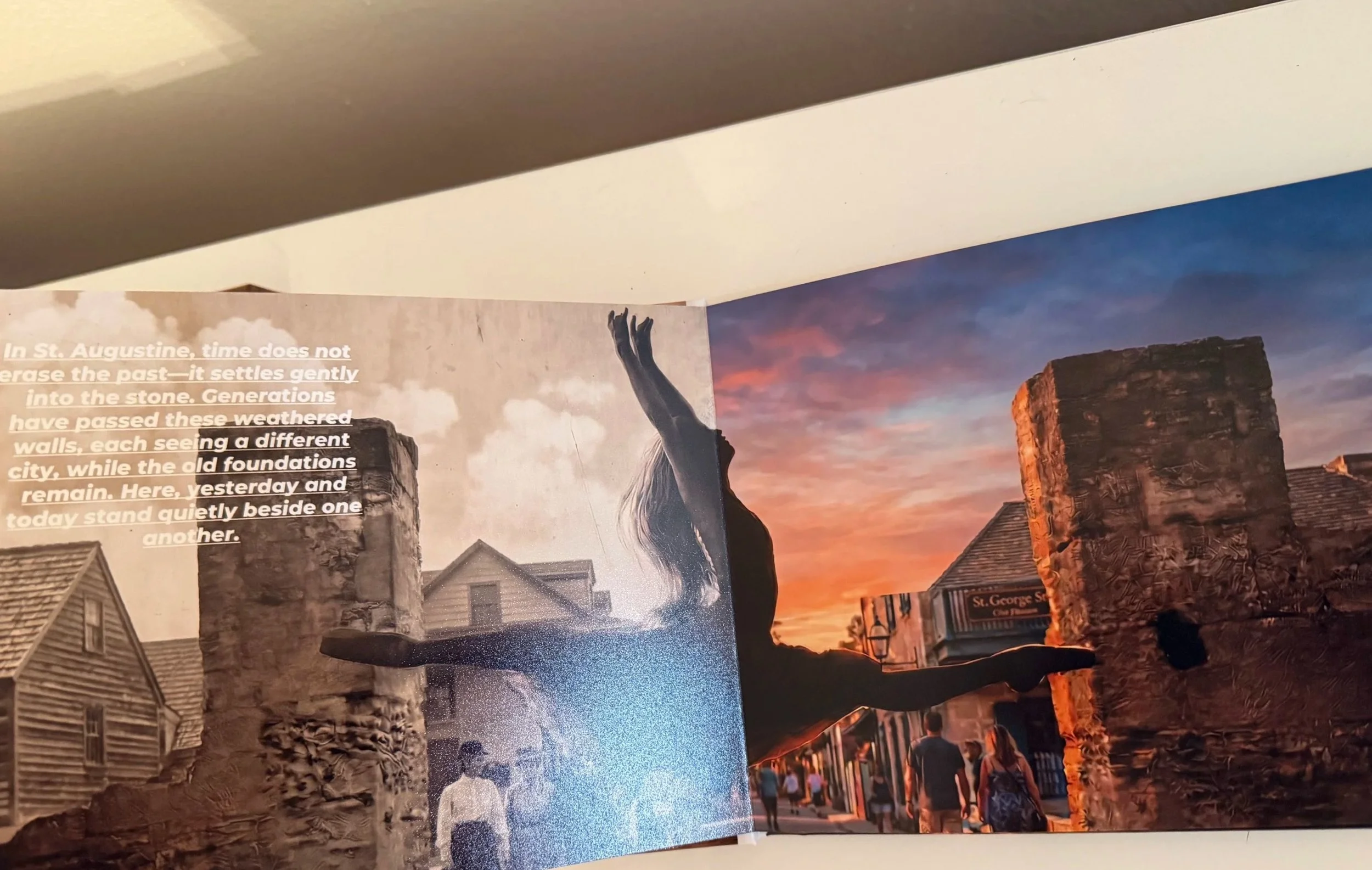 A photograph of historic ruins with modern houses in the background, taken at sunset with a colorful sky, and a group of people walking along a street. There is also and artist 'traveling through'; evocative of the past coming alive in this city.