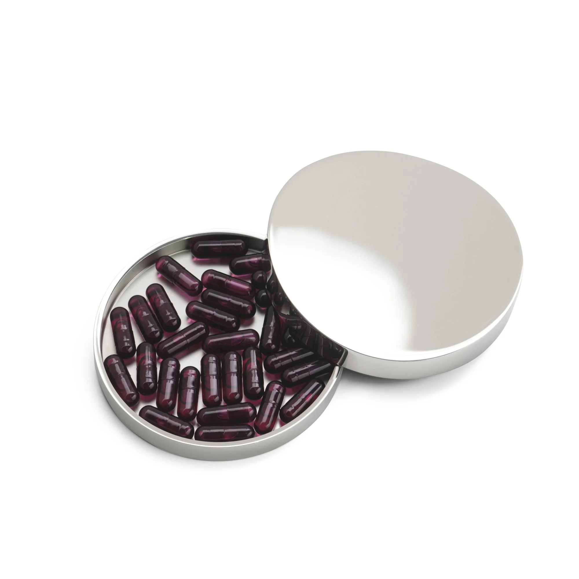Een witte ronde doos met een open deksel, gevuld met donkerrode capsules.