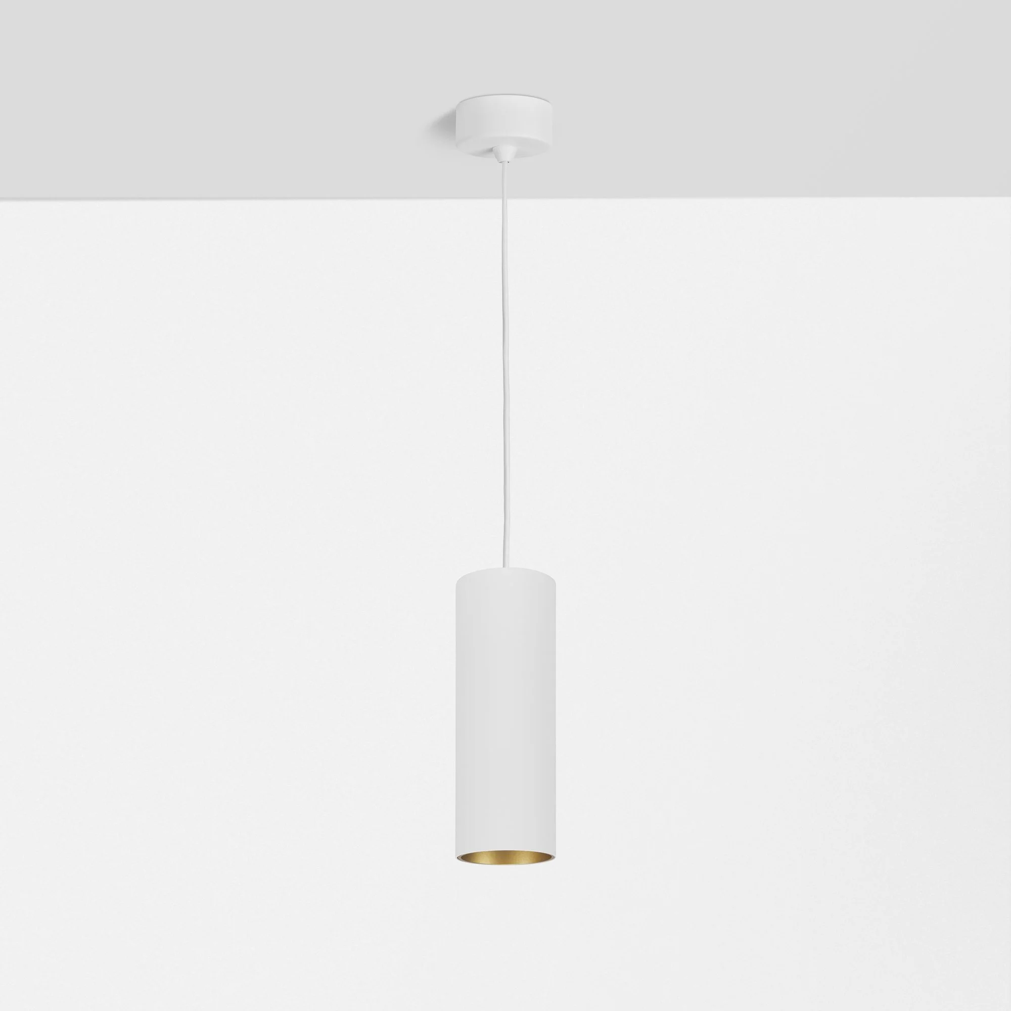 Een moderne witte plafondlamp met een witte snoer onder een witte plafond in een minimalistisch interieur.
