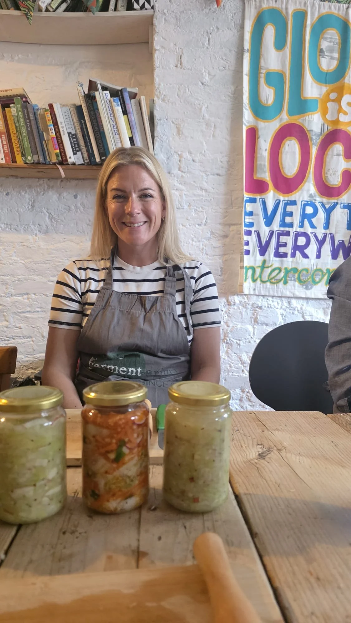 Lauren, co-founder of Pickled Revolution, in the kitchen with jars of fermented Brussels sprouts