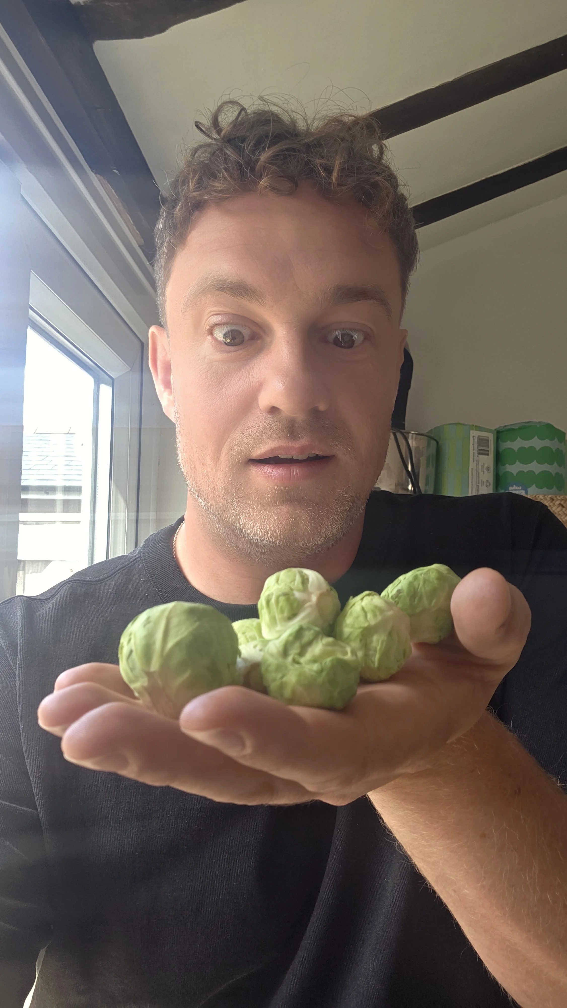 Rob from Pickled Revolution holding fresh Brussels sprouts
