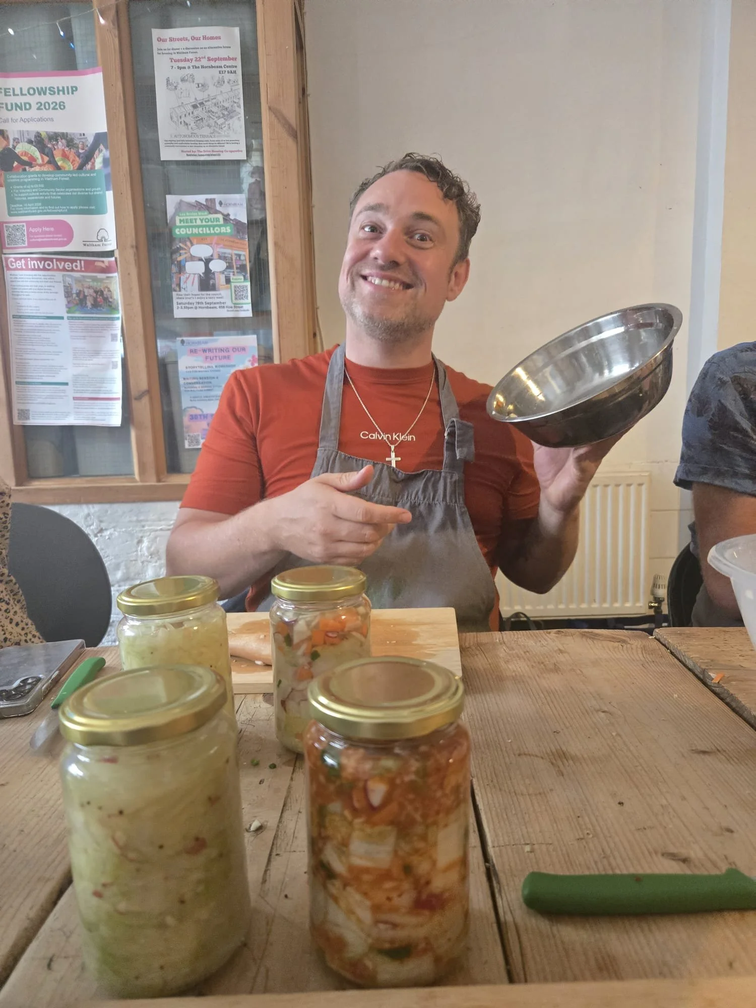 Rob, co-founder of Pickled Revolution, smiling while preparing a batch of pickled Brussels sprouts
