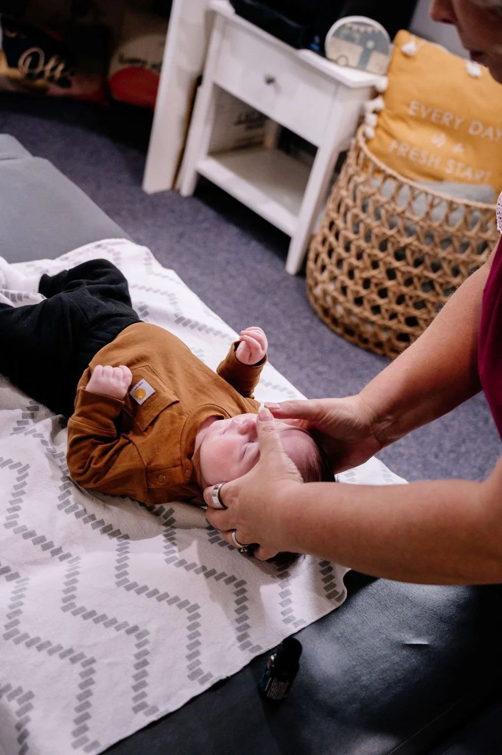 Dr. Brenda Fairchild, pediatric and family chiropractor performing a gentle adjustment on a baby with constipation, reflux, colic, and torticollis