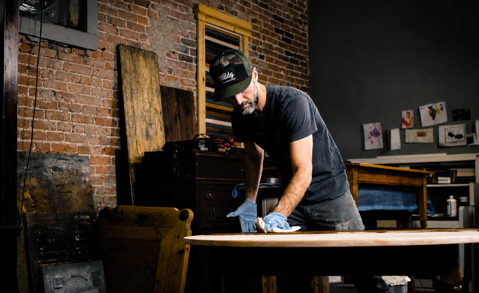 Chris Kunicki hand-finishing furniture in the Kunicki Restoration workshop in Denver.