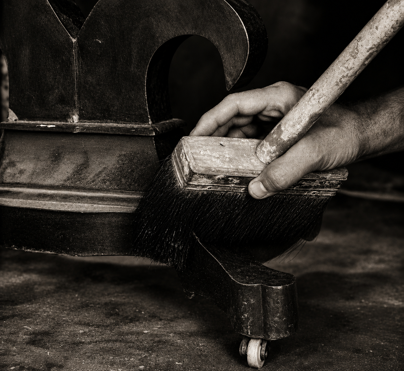 Chris Kunicki working by hand on a furniture restoration project in his Denver workshop.