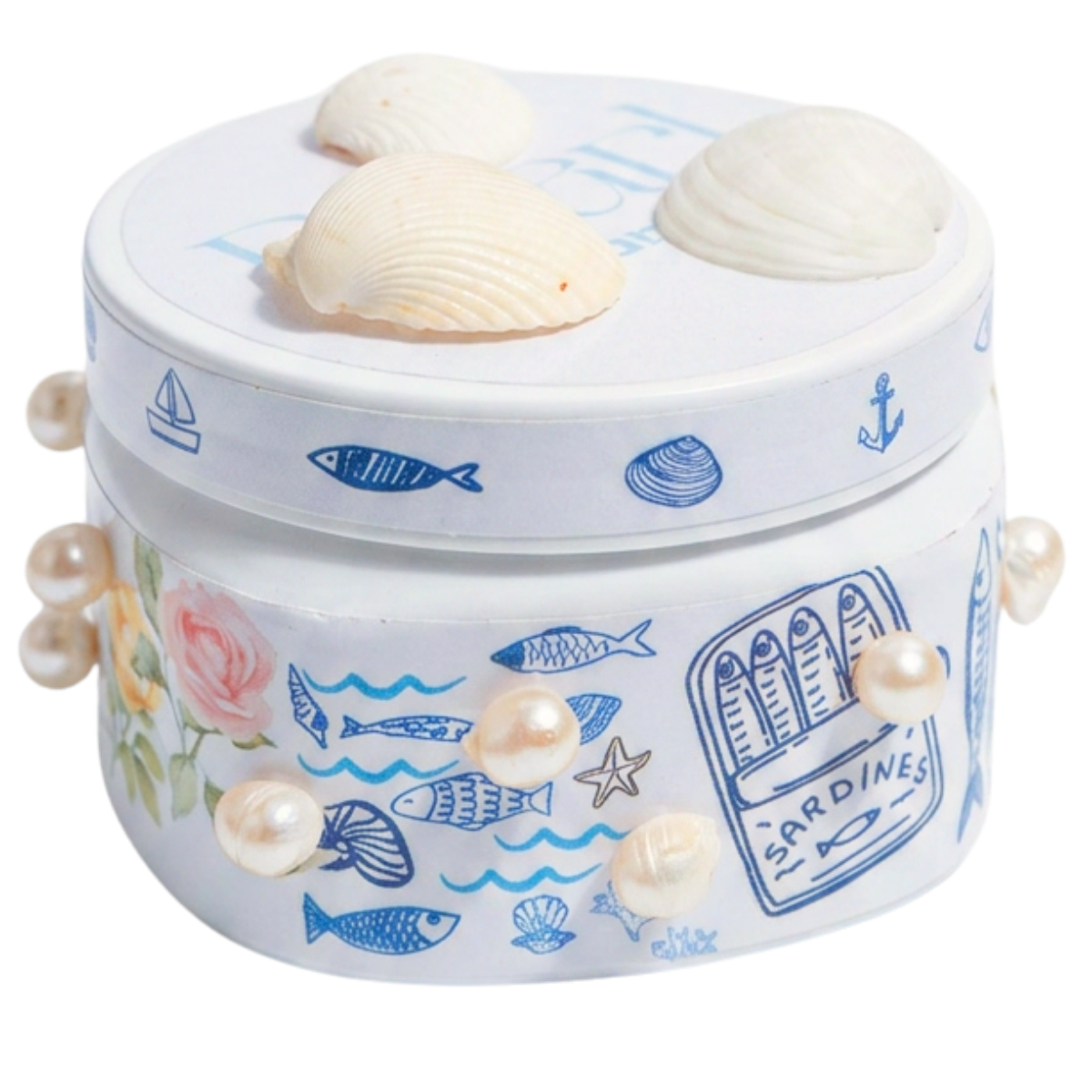 Decorative round box with a nautical theme, adorned with illustrations of fish, shells, starfish, and an anchor, decorated with faux pearls, and topped with three large seashells.