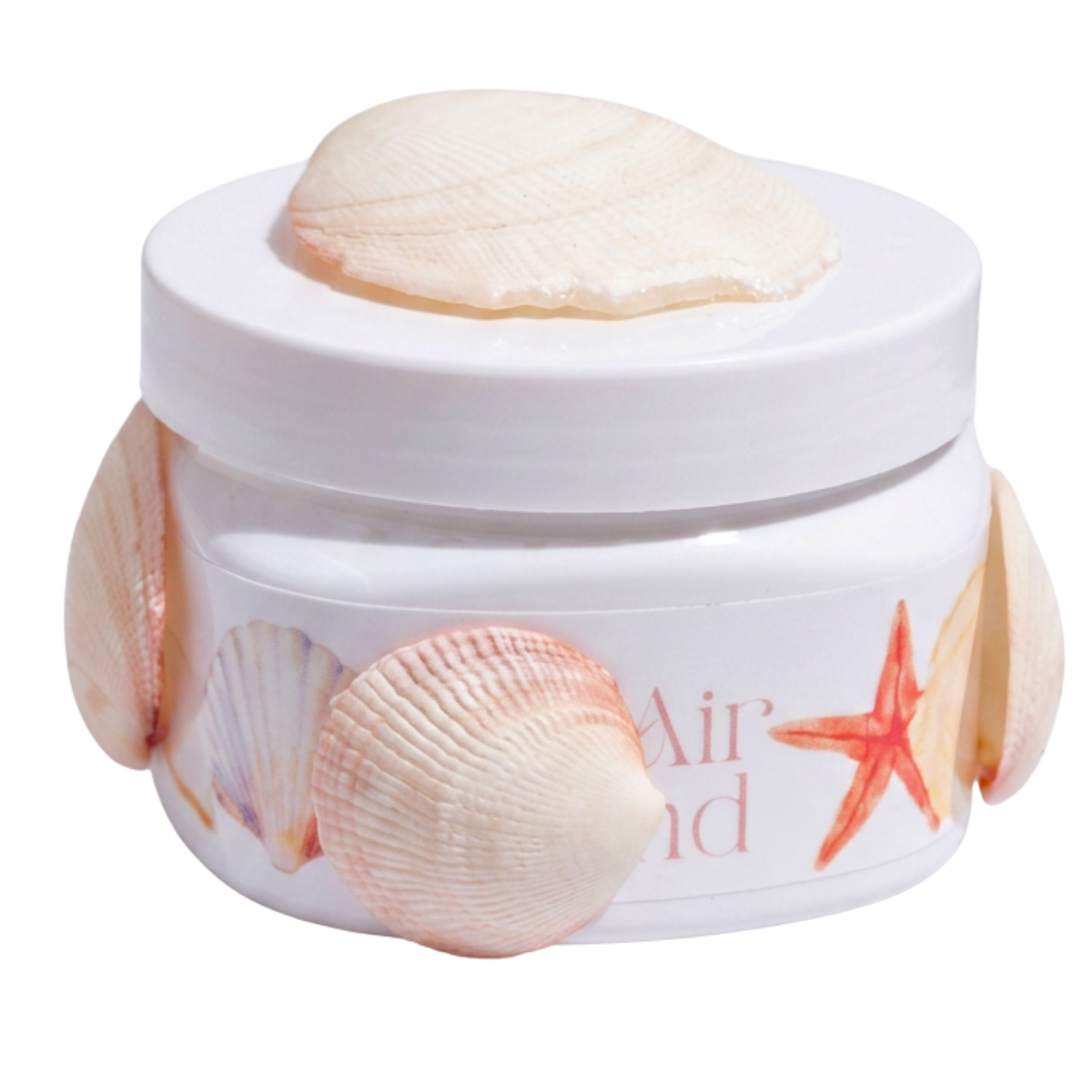 A white container with a seashell and starfish design, containing cream with a seashell on top, labeled 'Air'