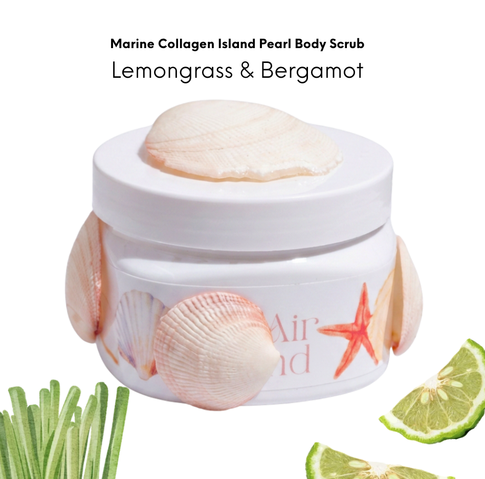 Container of Marine Collagen Island Pearl Body Scrub with lemongrass and bergamot, decorated with seashells and lime wedges.