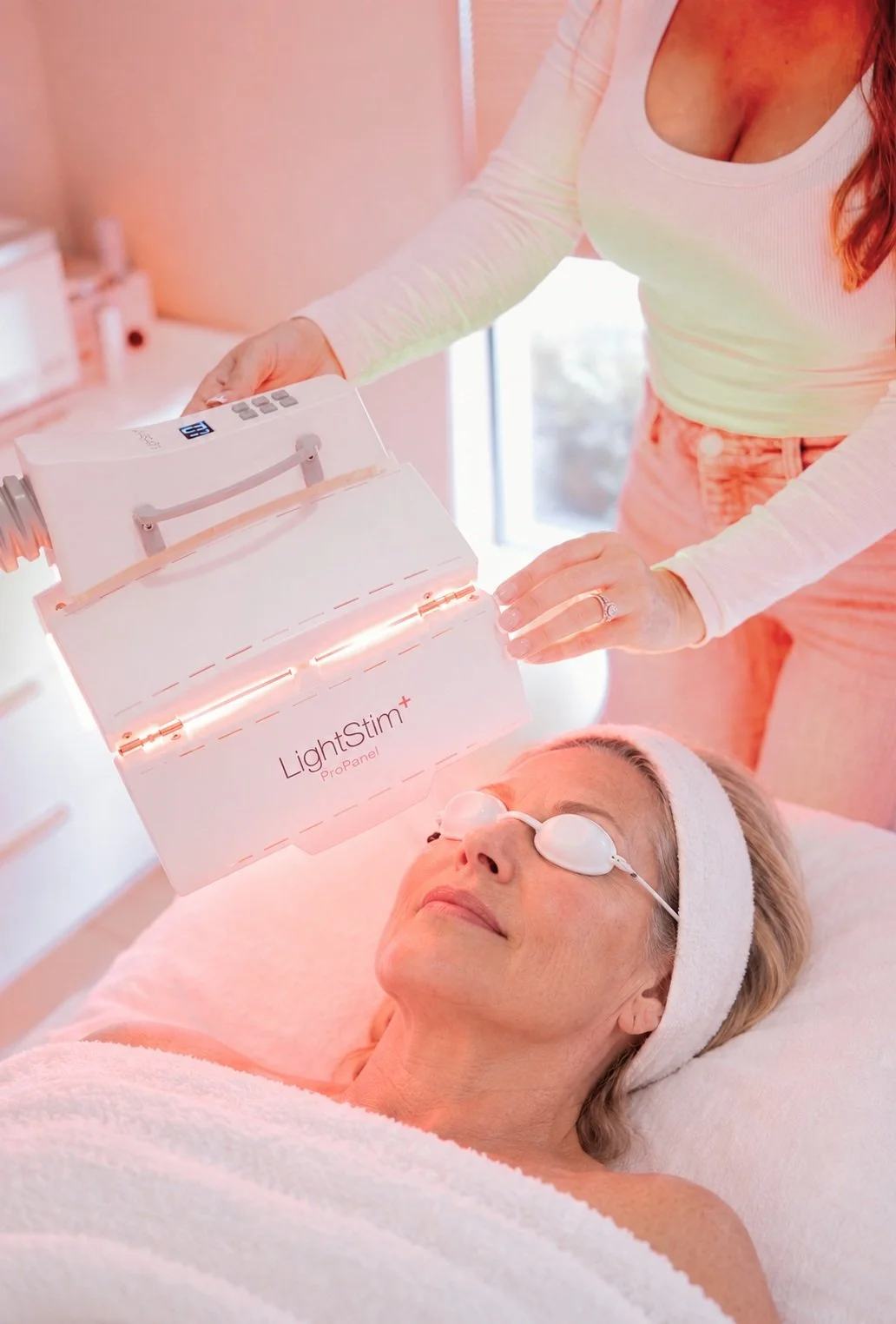 Client relaxing during an LED light therapy facial with LightStim at Chrissy Jacobs Esthetics in Santa Cruz