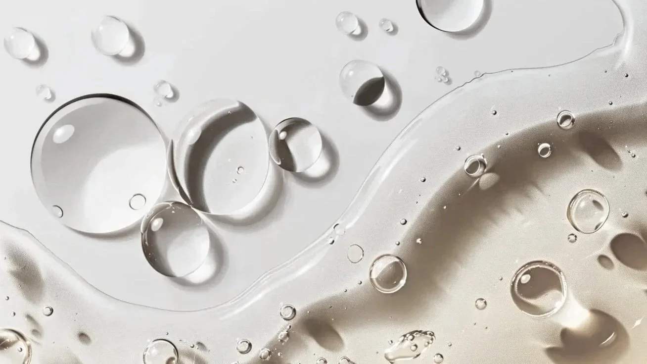 Clear water droplets on a smooth surface, a fresh look at hydrating facials for women in Santa Cruz California