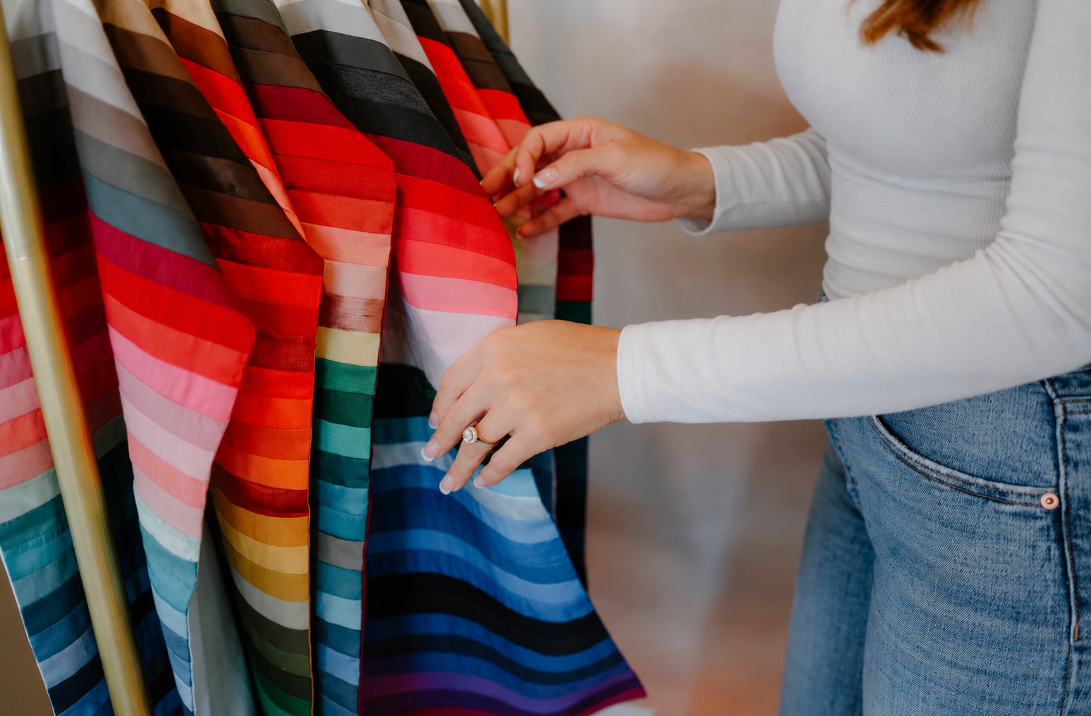 Hands sorting colorful draping fabrics during a private group seasonal color analysis appointment in Santa Cruz