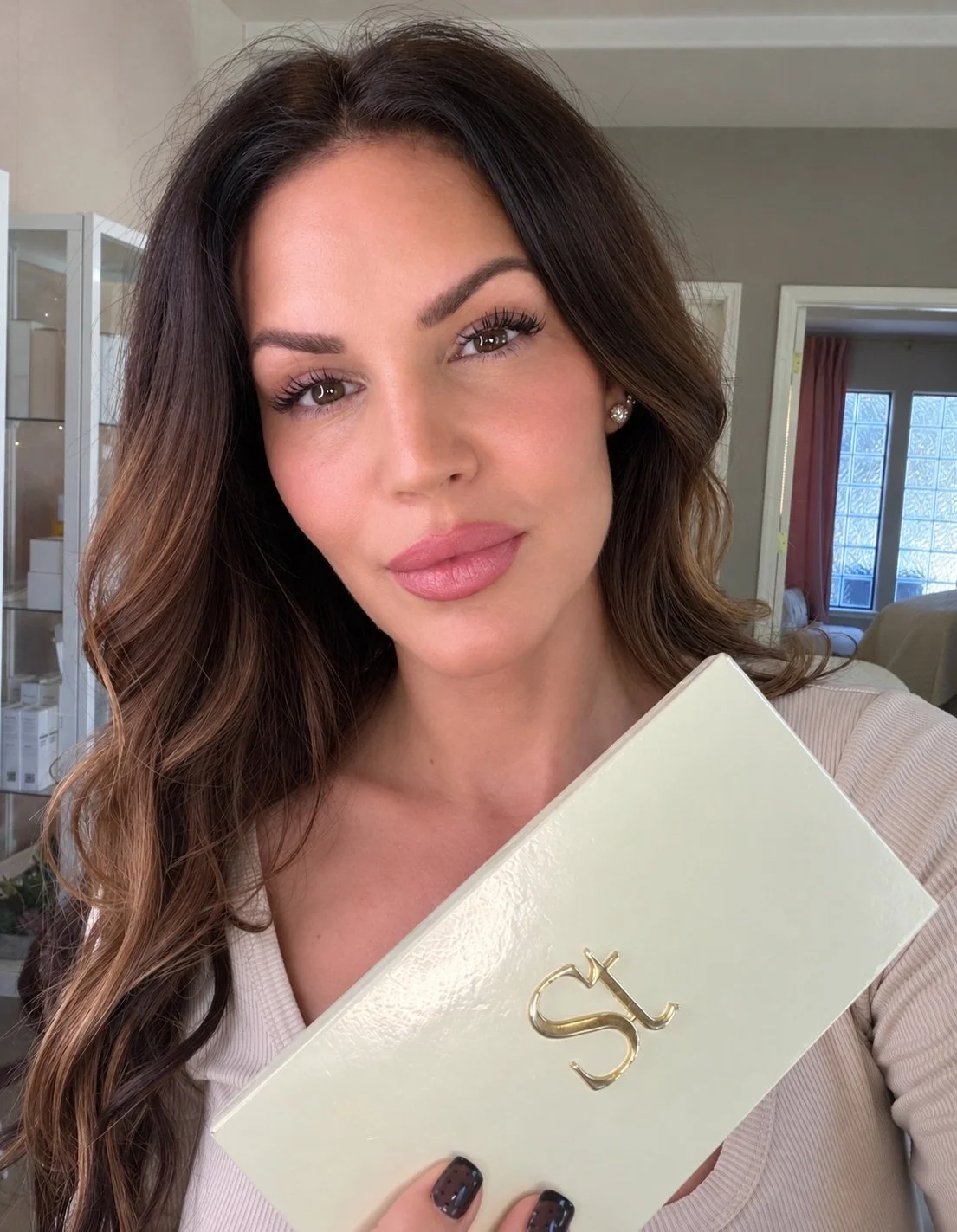 Chrissy Jacobs, Santa Cruz esthetician, holding a custom Seint makeup box for women in Capitola California