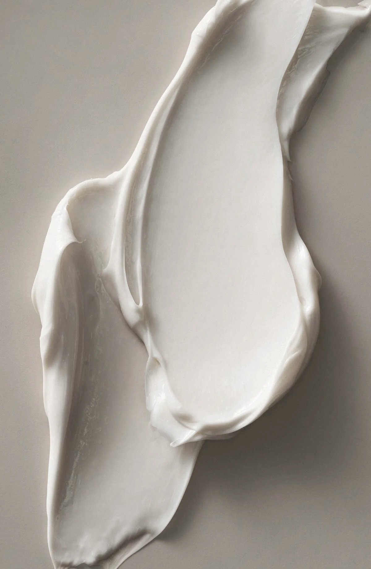 Rich white cream texture, a nod to the personalized skincare used in custom facials for mature skin