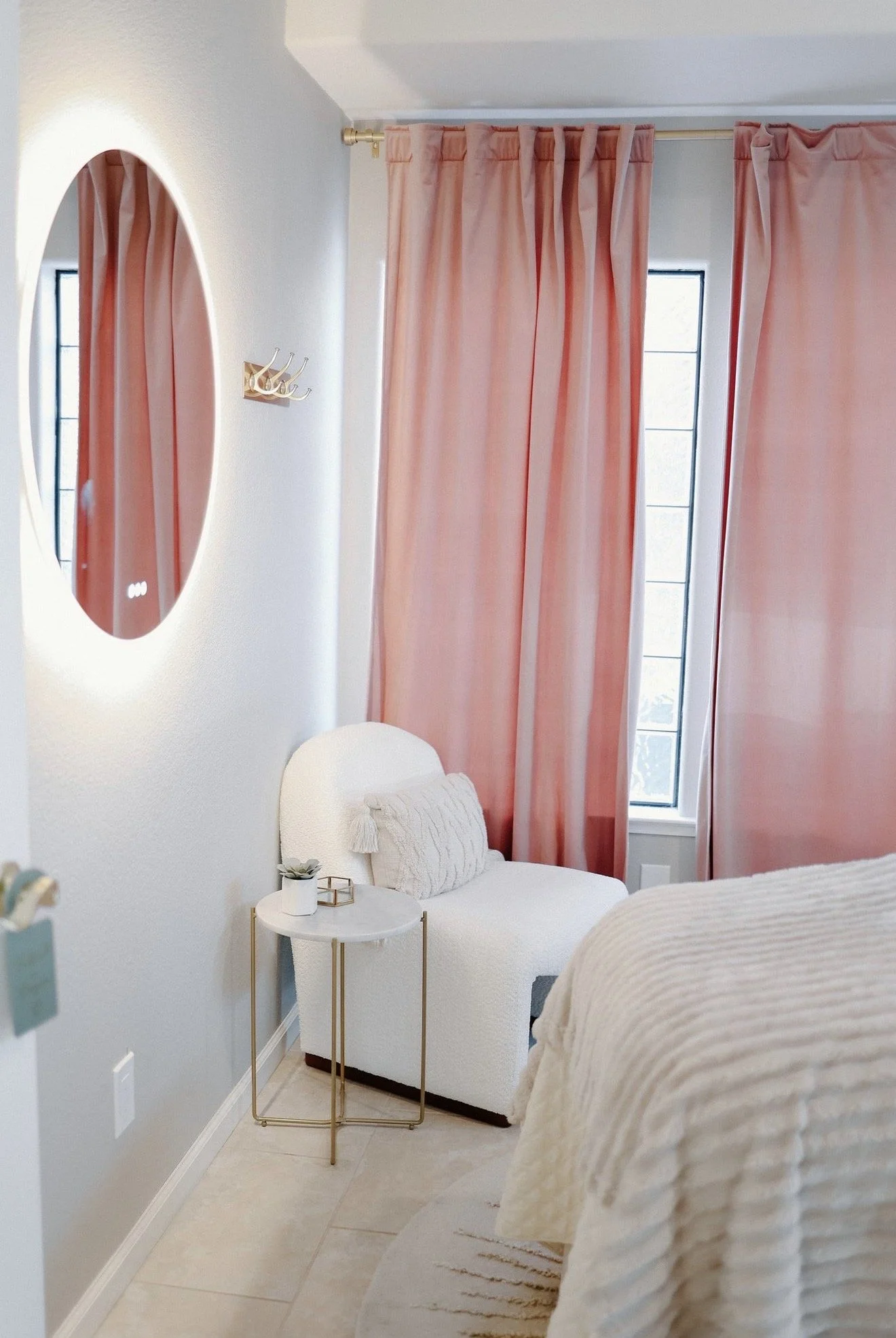 Bright, welcoming corner of luxury spa private esthetics studio with soft pink curtains and a mirror in Seabright Santa Cruz