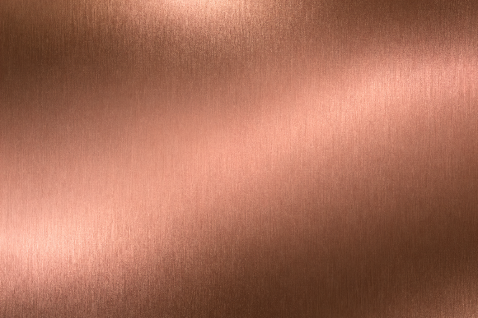 Close-up of a metallic, rose gold surface with a brushed texture.