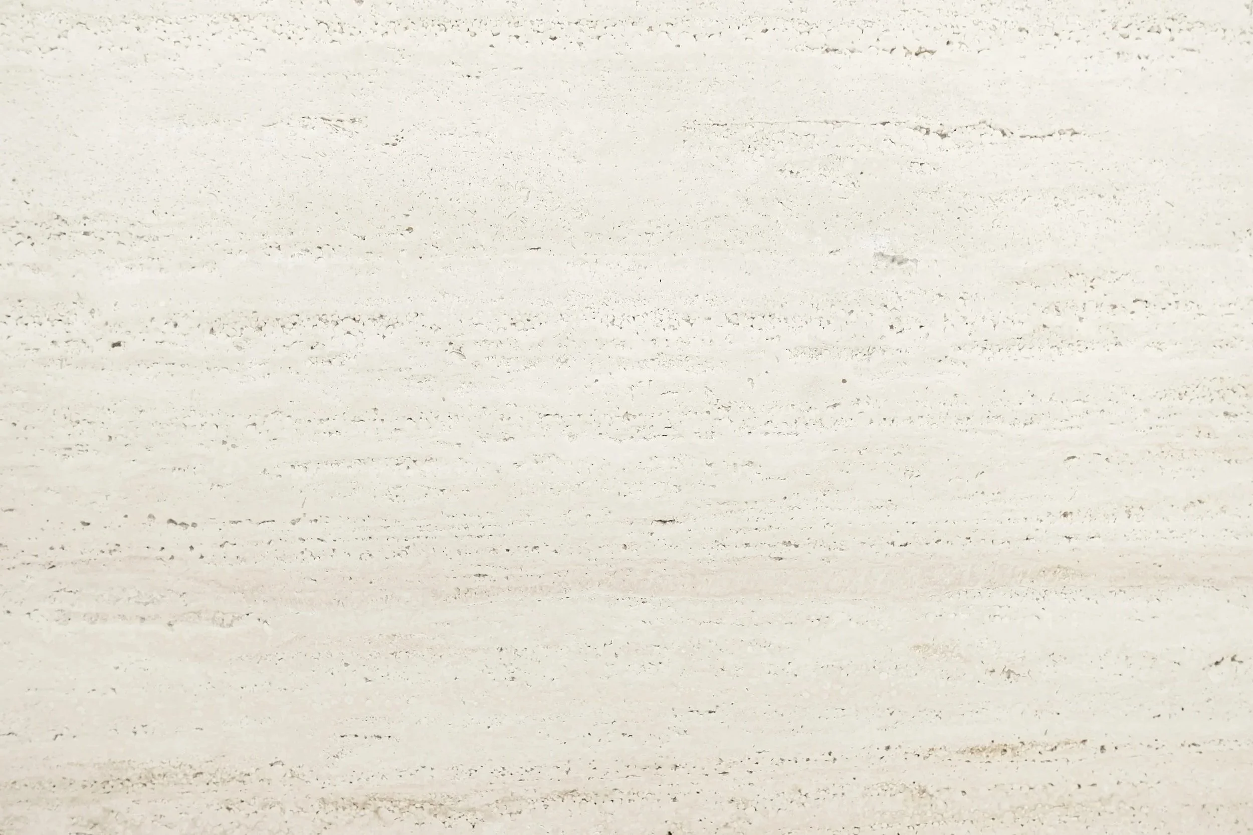 Close-up of a white marble surface with light gray veining.