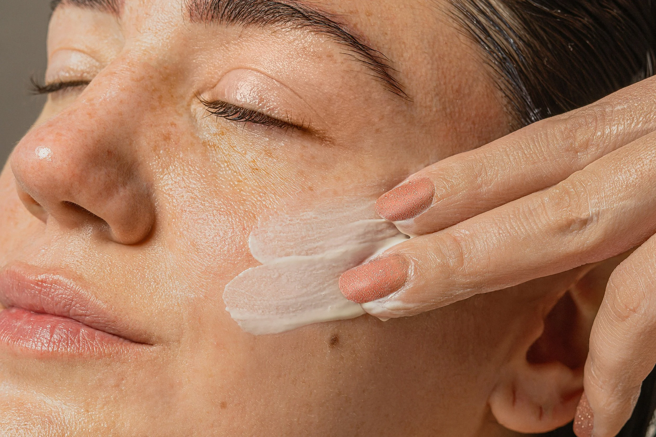 Esthetician applying a treatment mask during a custom facial, care tailored to what your skin needs now
