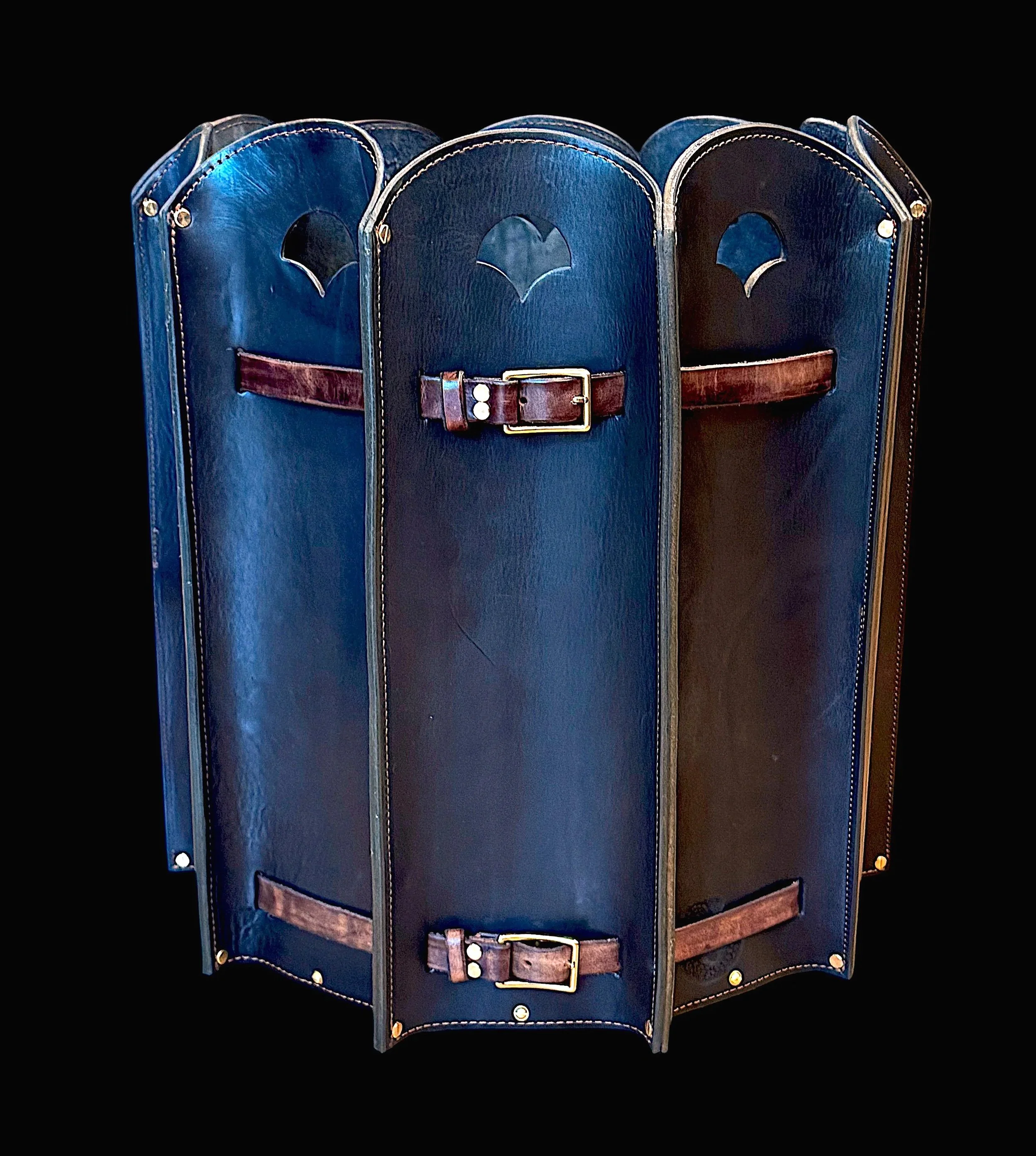 A rotating display of three vintage leather bags with a black background.