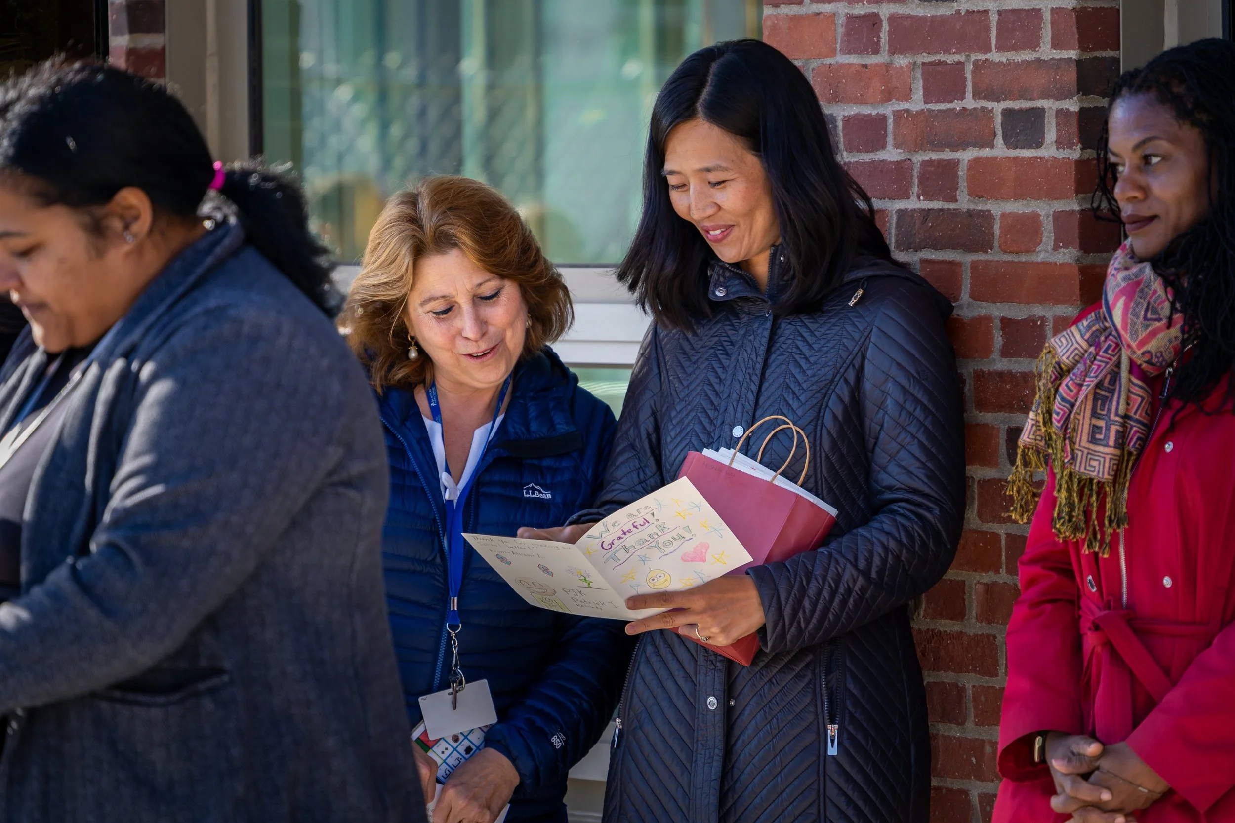 City of Boston Mayor Michelle Wu reads a handwritten letter next to Boston Public Schools Superintendent Mary Skipper.  