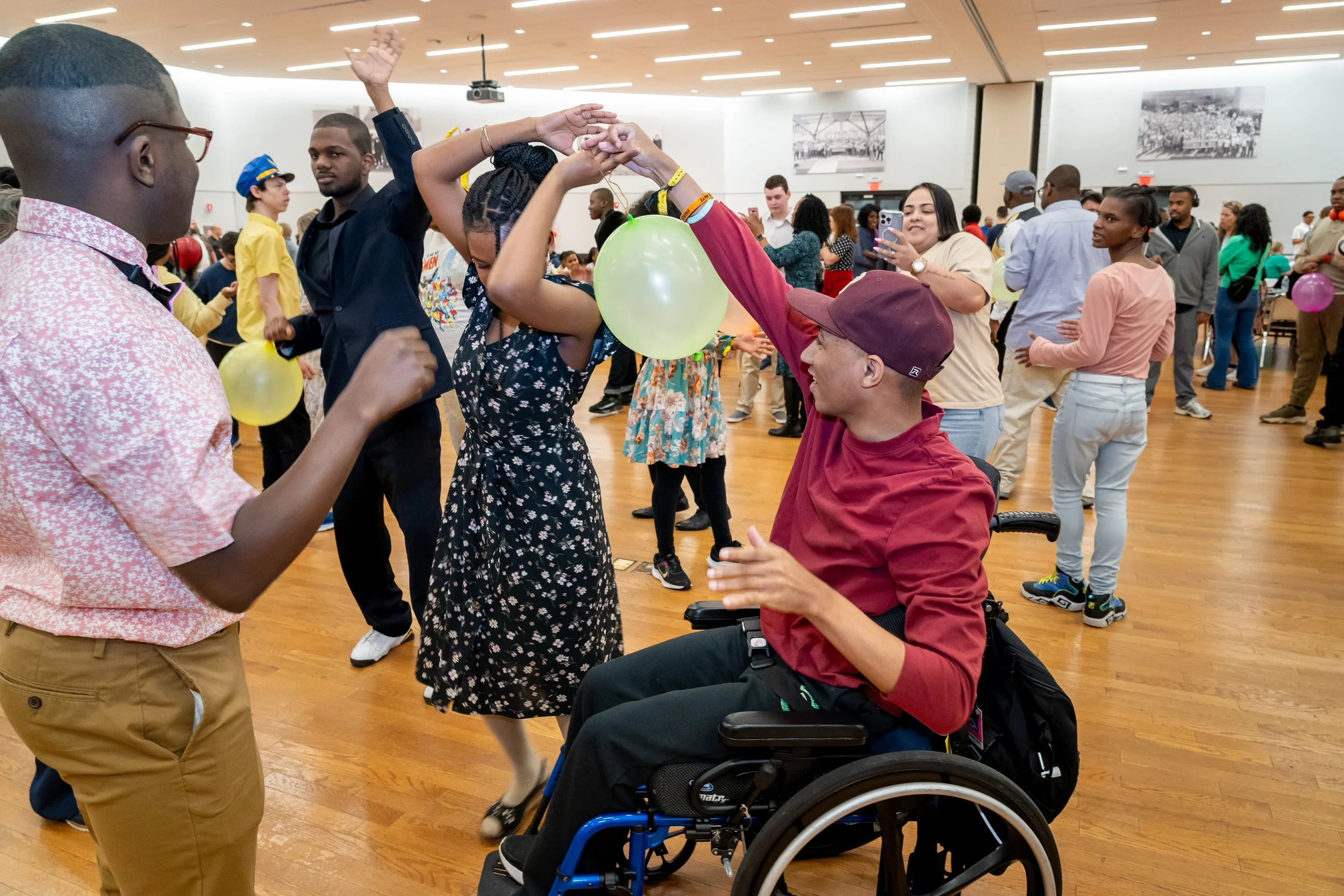 Boston Public Schools students, one in a wheelchair, dance together.