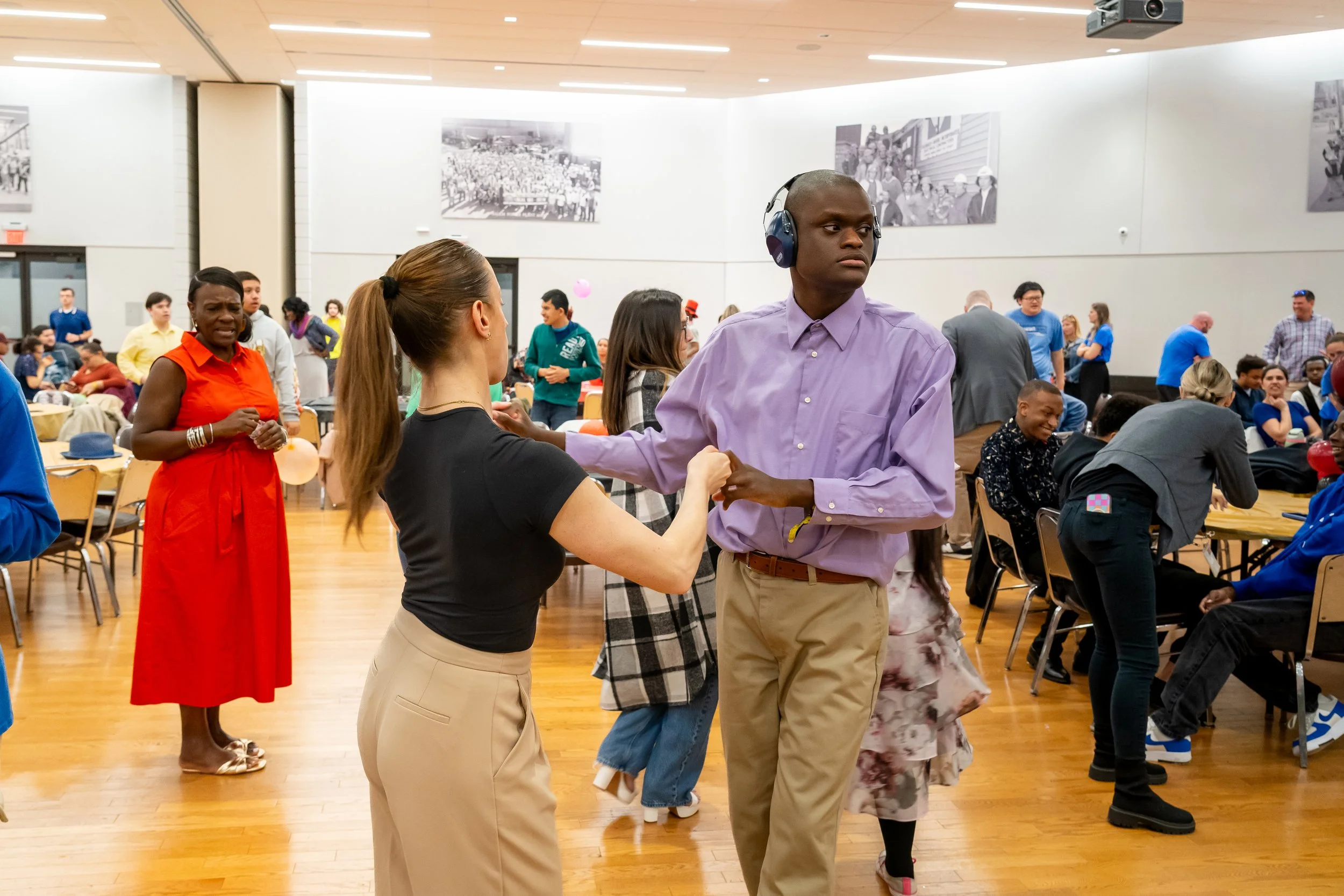 Boston Public Schools student and staff members dance together.