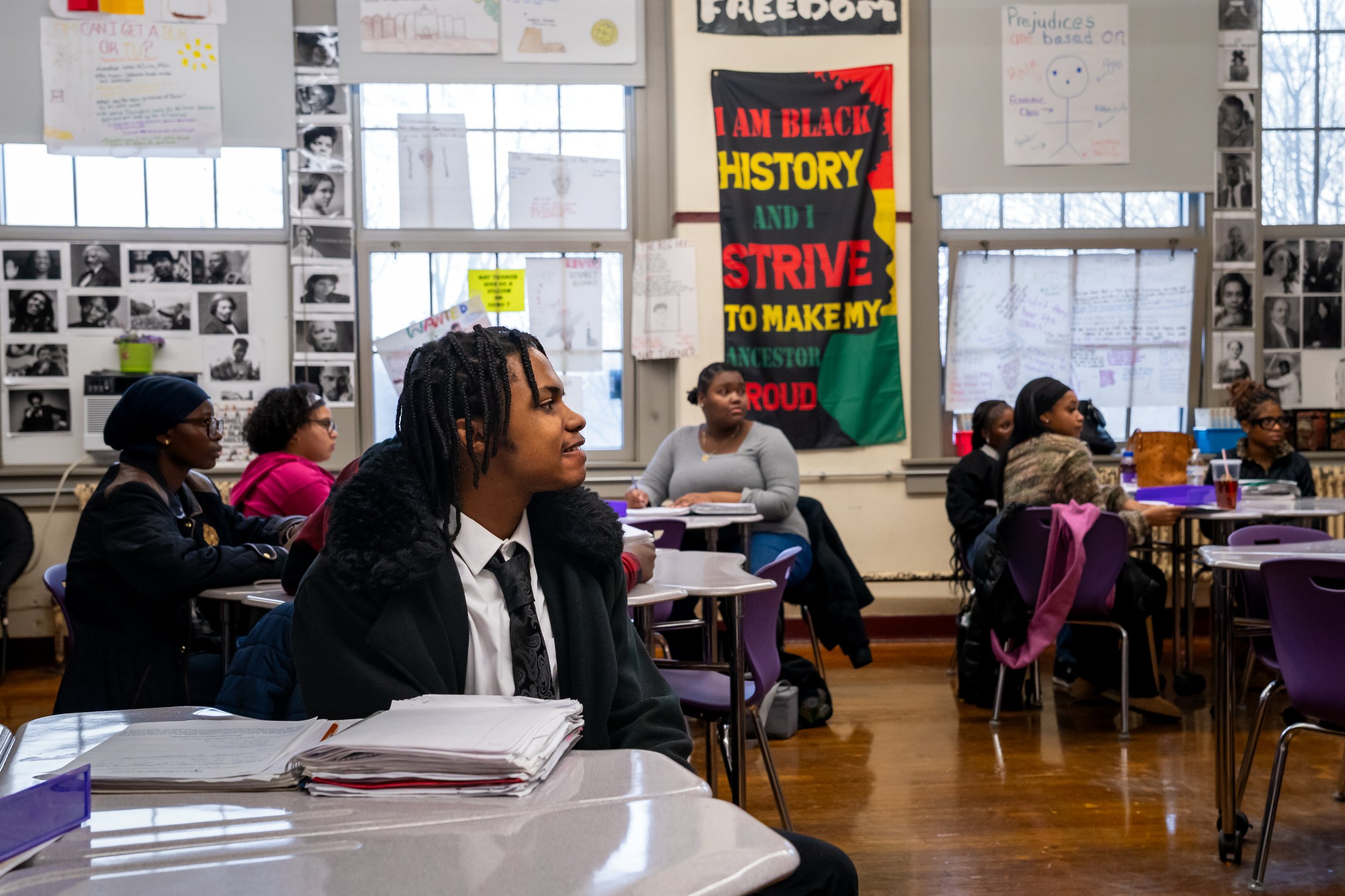 Boston Public Schools students sit and listen to Boston Public Schools educator Tanisha Milton's lesson in her AP African American Studies class.