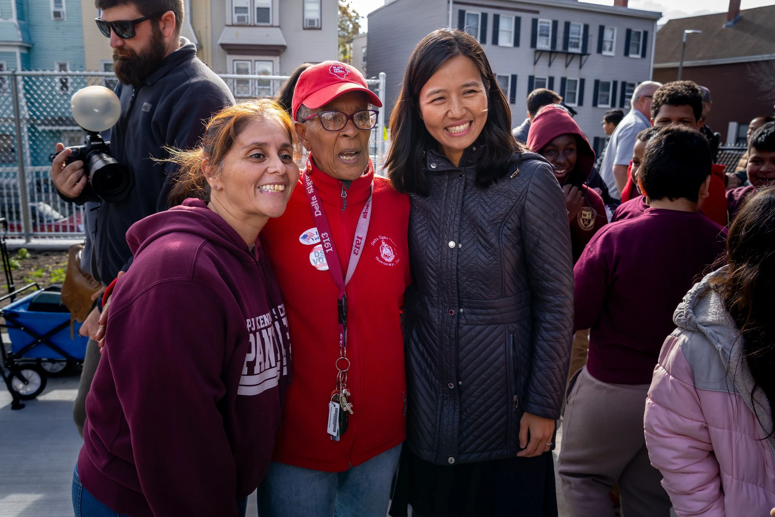 City of Boston Mayor Michelle Wu smiles and poses for a photo with Kennedy Elementary staff members. 