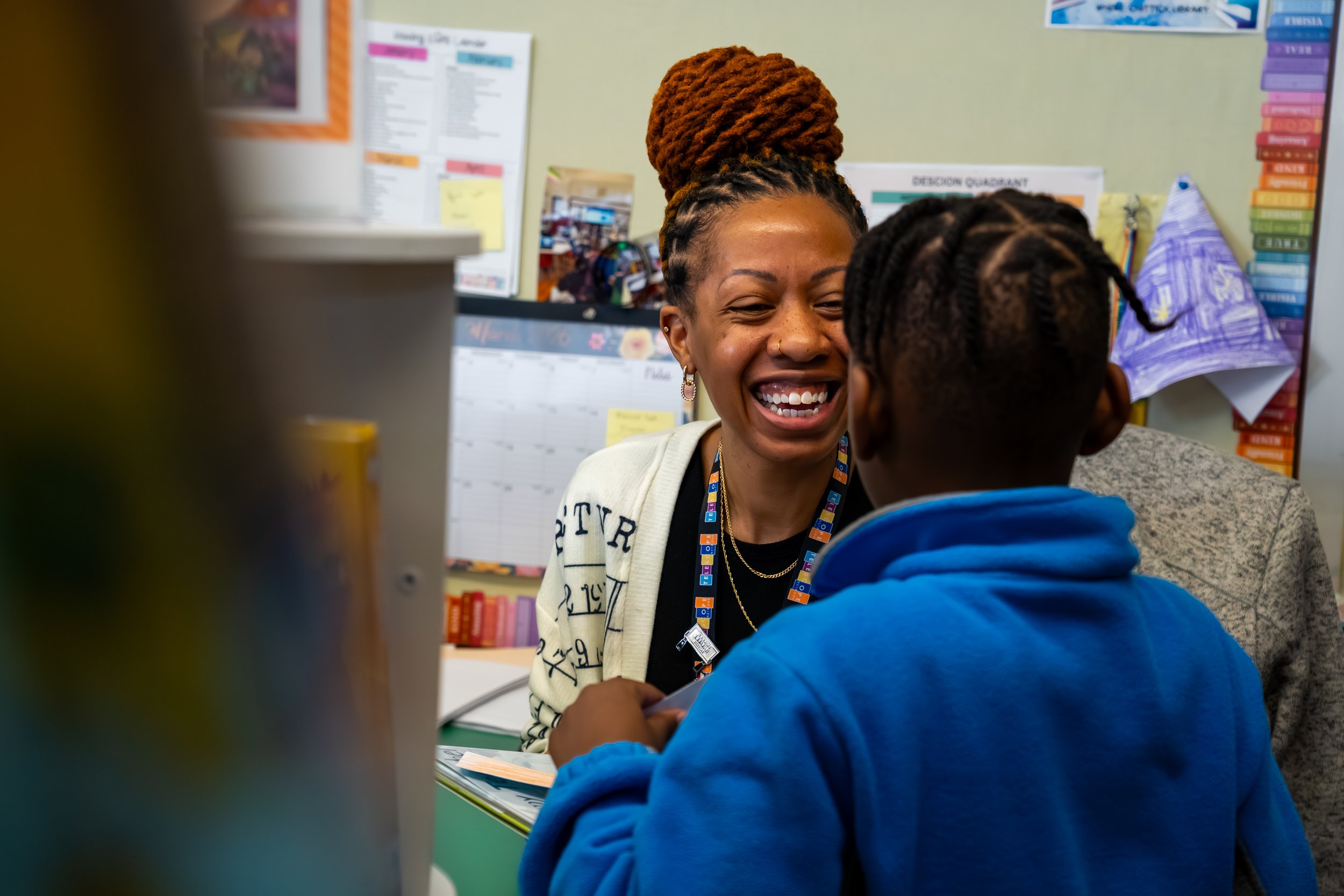 Boston Public Schools librarian Kadian Simmonds smiles at a student.