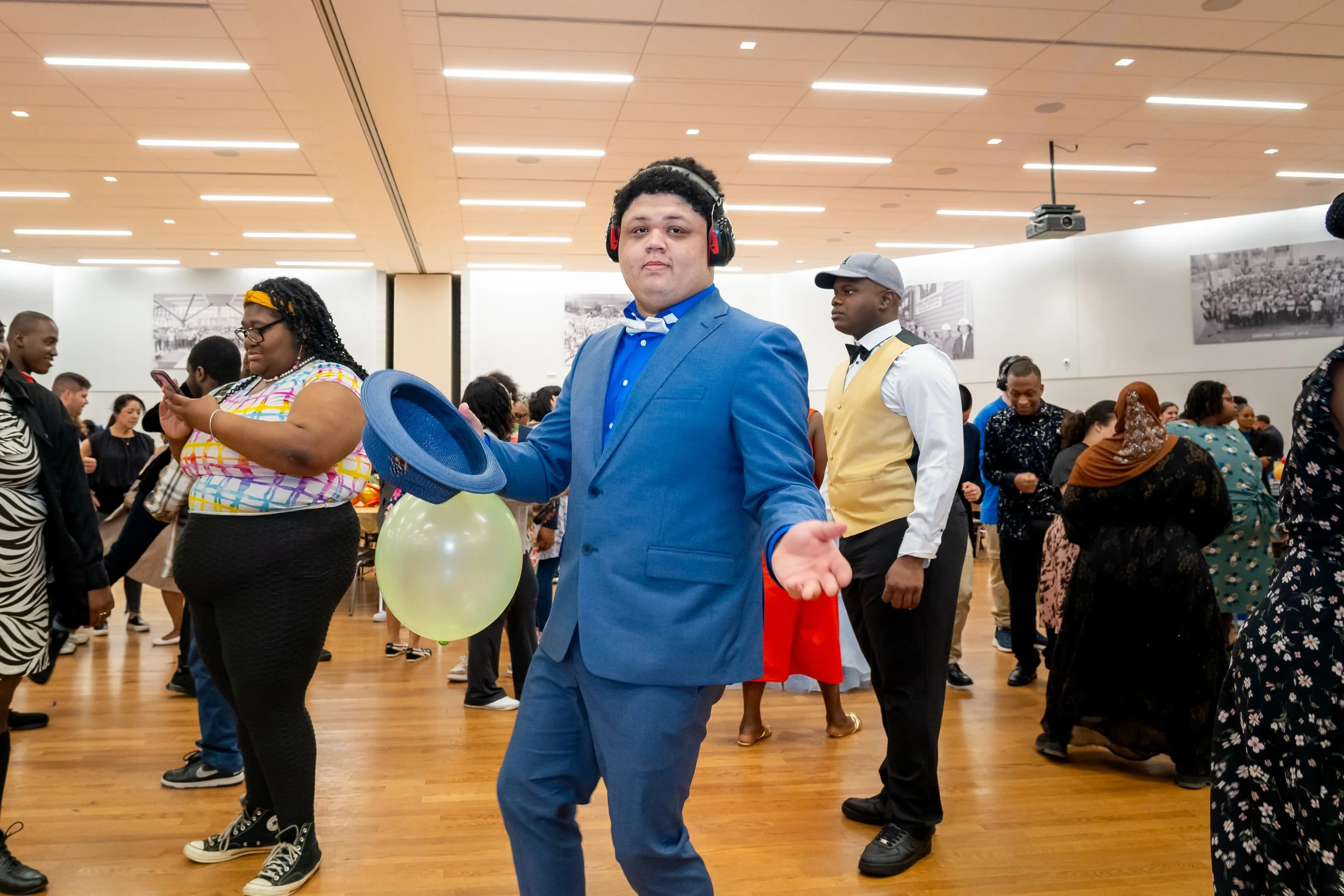 Boston Public Schools student in a blue suit dances. 